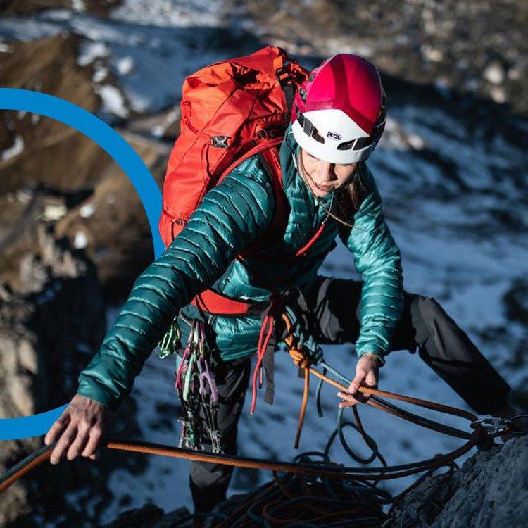 An image of a woman climbing outdoors on a rockface.