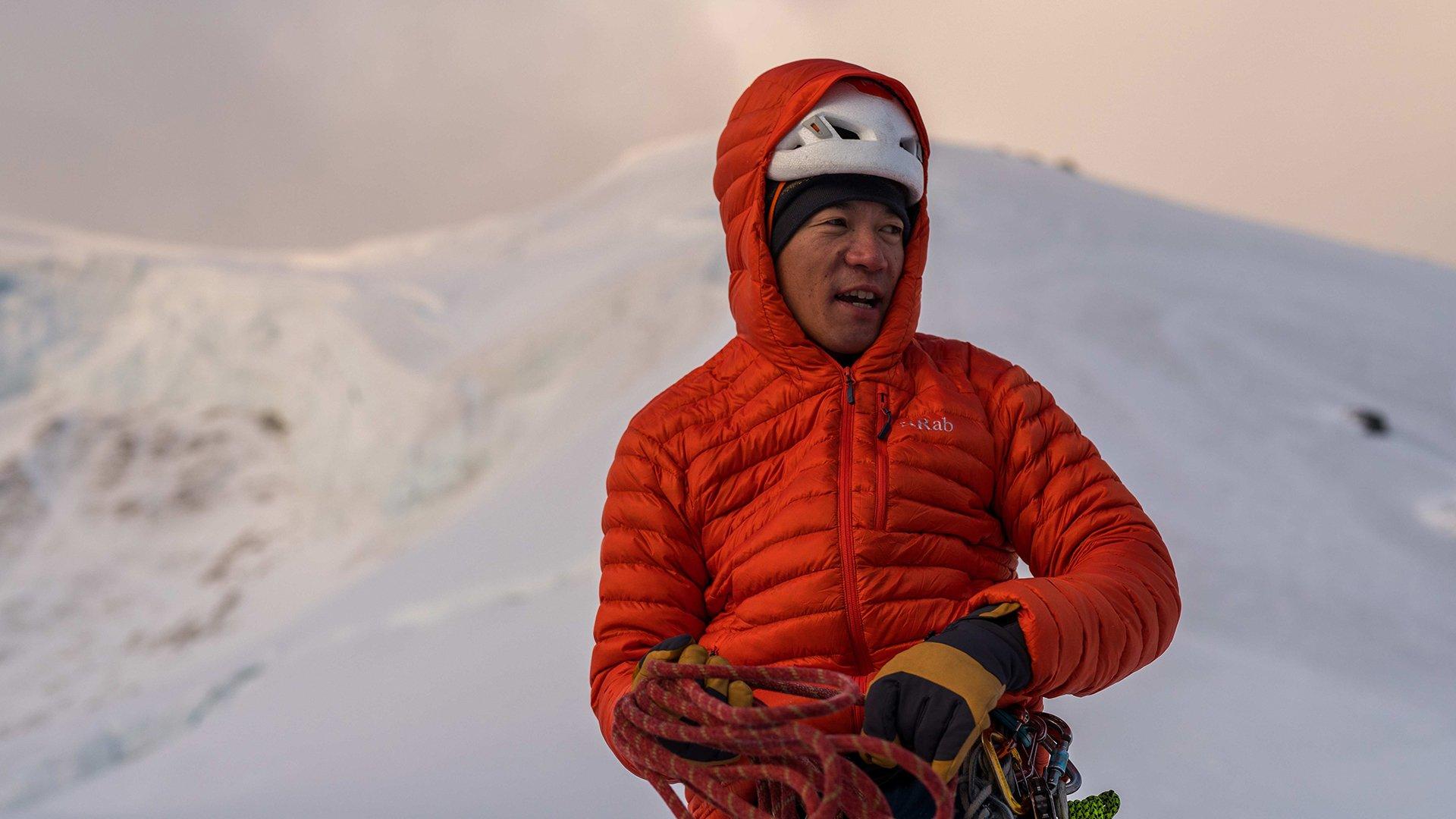 male climber getting ready for a winter climb in Rab microlight jacket