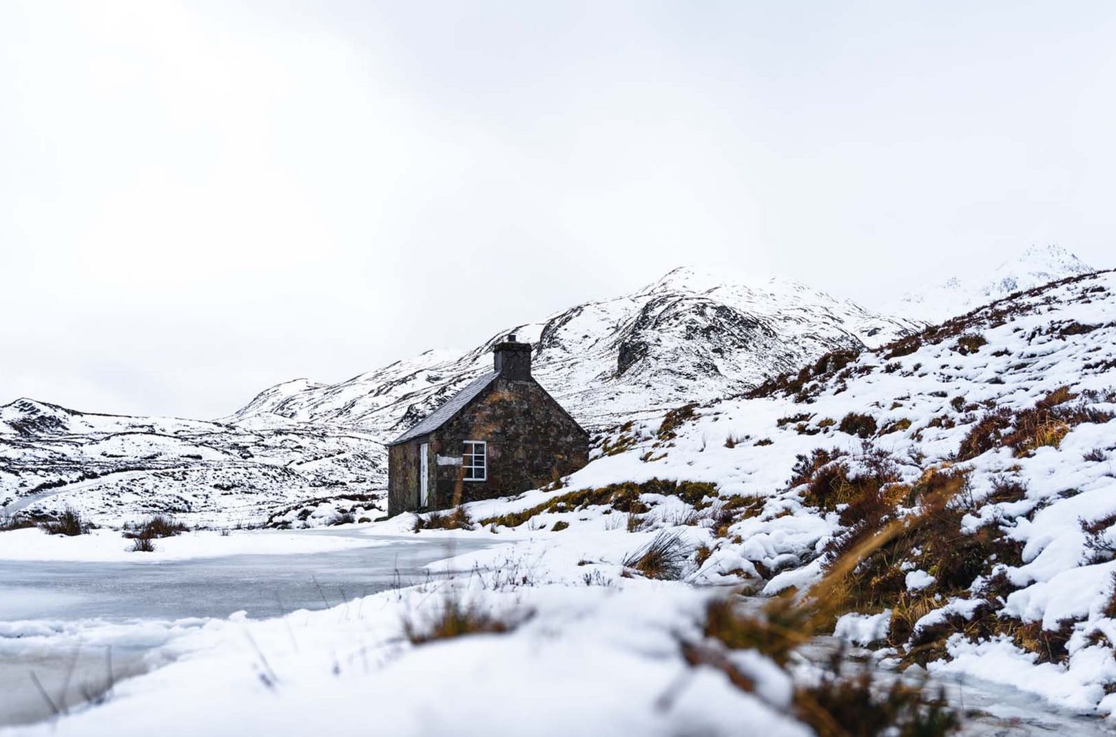 snowy scene of a bothy in Scotland