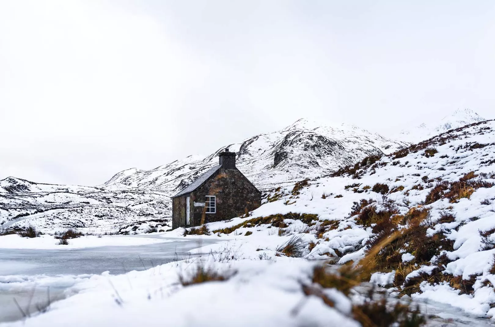 snowy scene of a bothy in Scotland