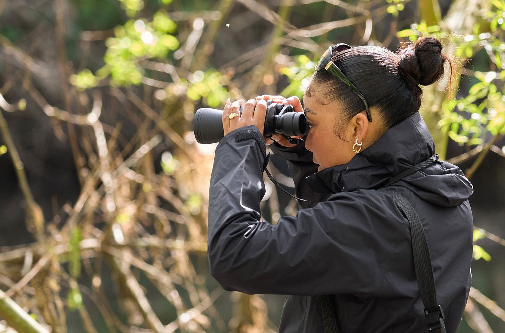 Lira, a Flock Together member, looking through some binoculars