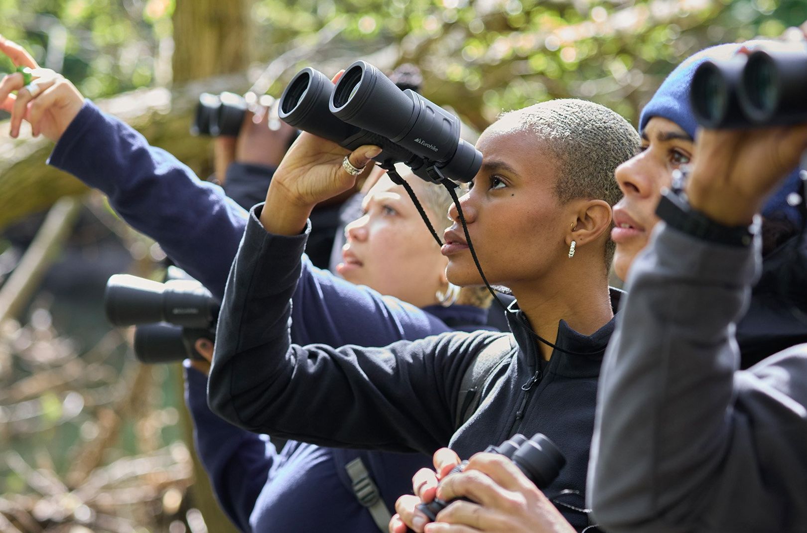 Flock Together members looking through binoculars