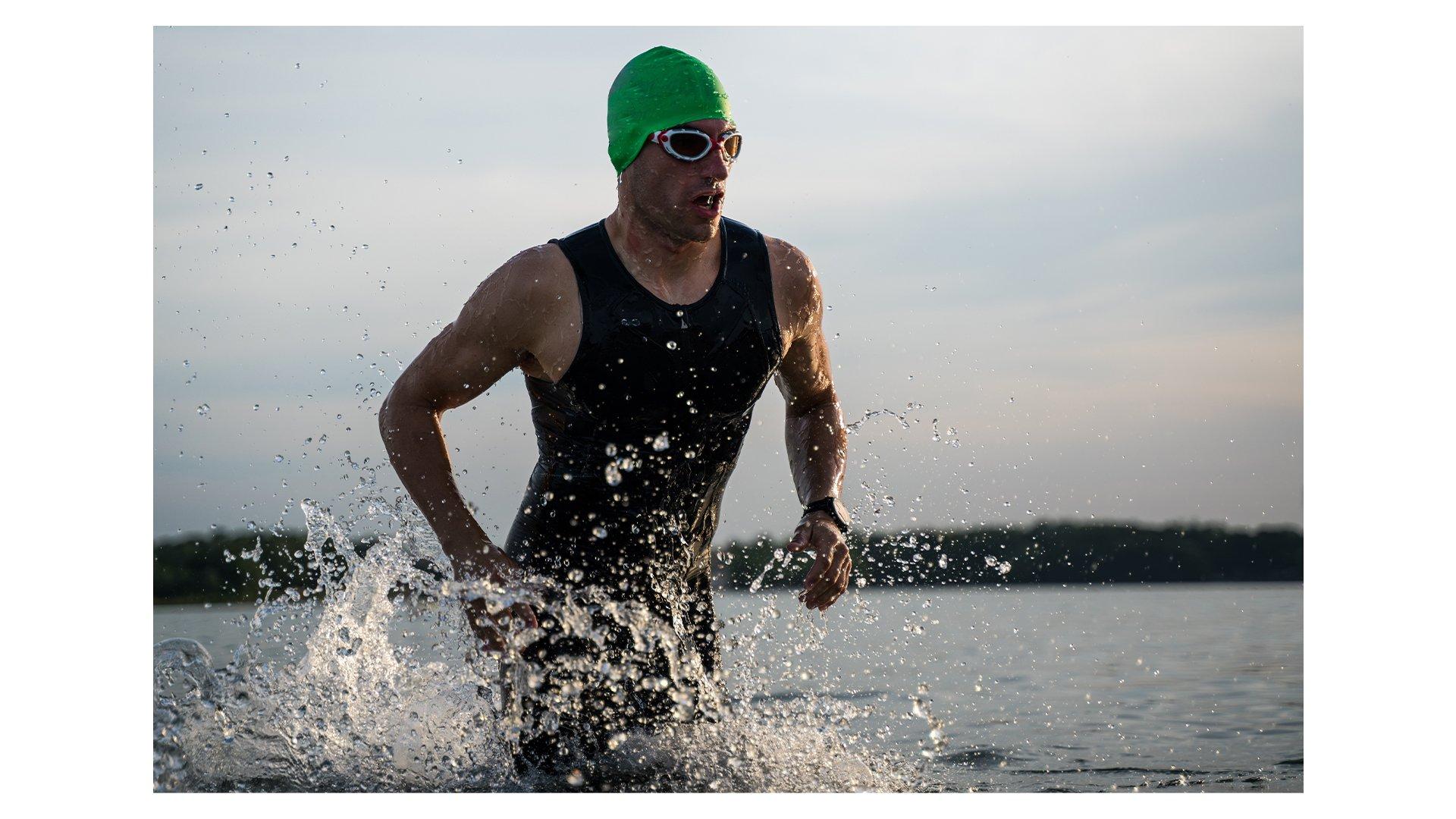 A triathlete exiting the water after the swimming section of a race