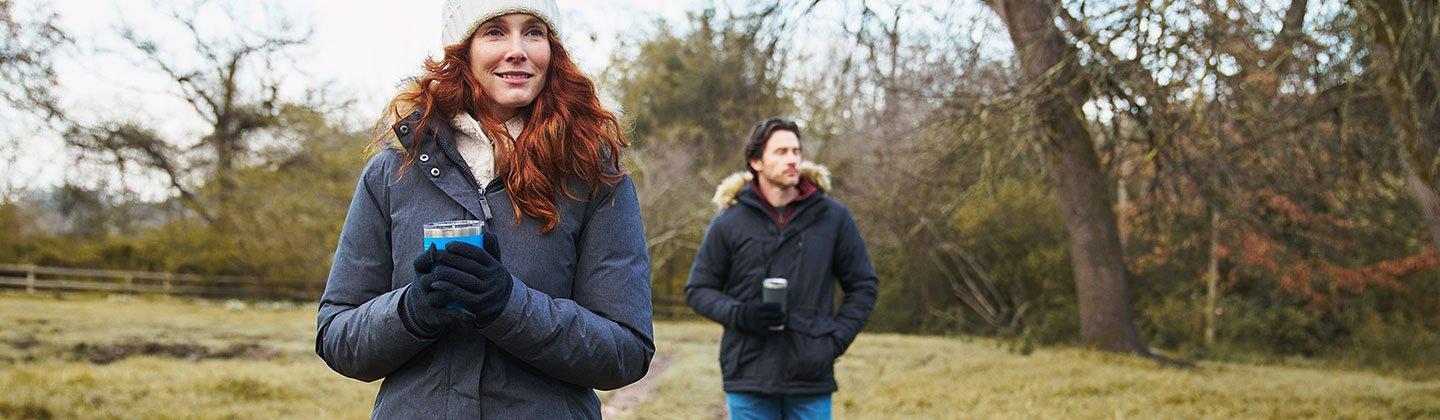 Woman and man wearing parka jackets