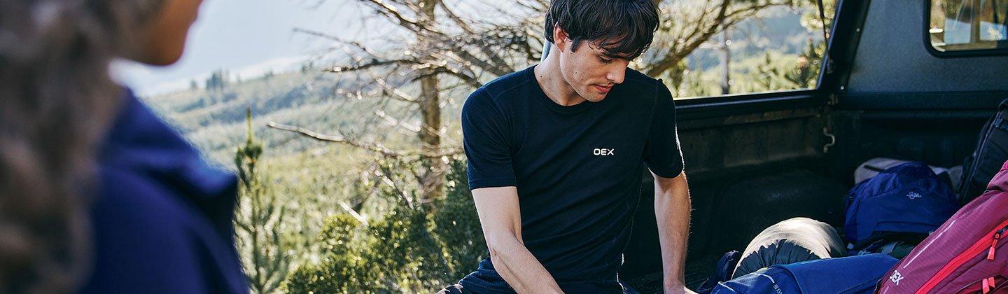 Man wearing baselayer packing his bag