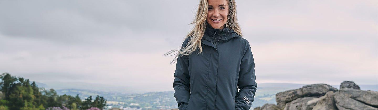 Woman smiling on hill top wearing a 3in1 jacket