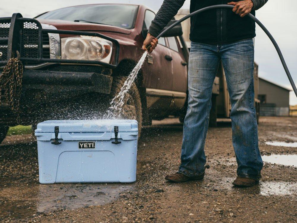 Man washing down Yeti cooler box