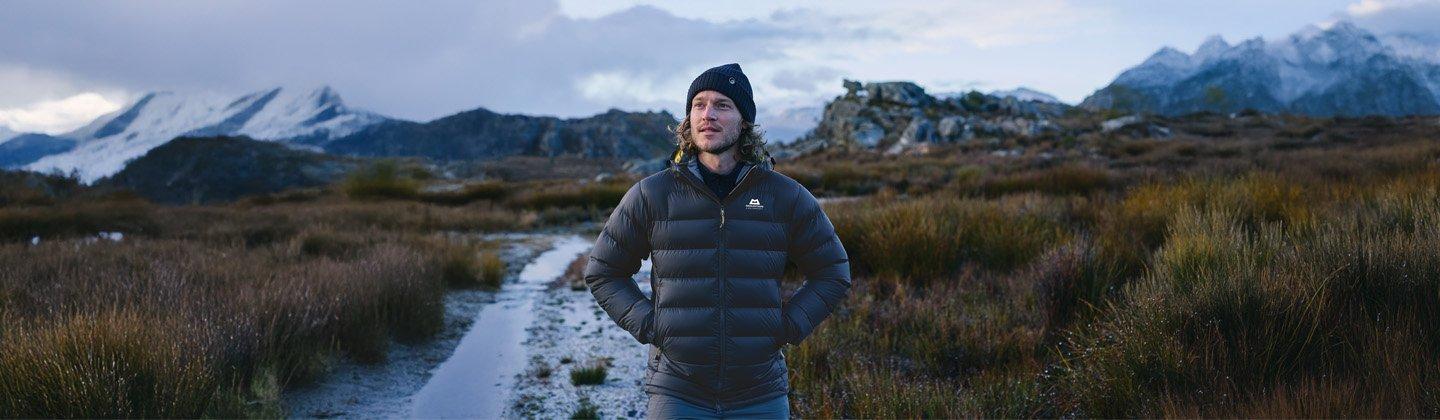 Person wearing a down jacket in the cold mountains