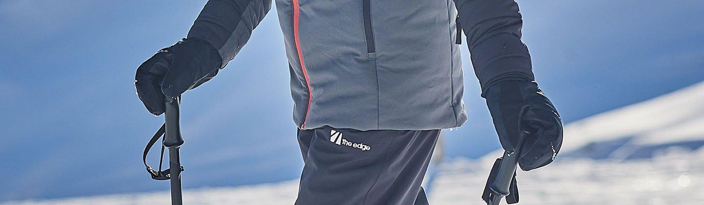 A closeup of a person wearing ski mitts