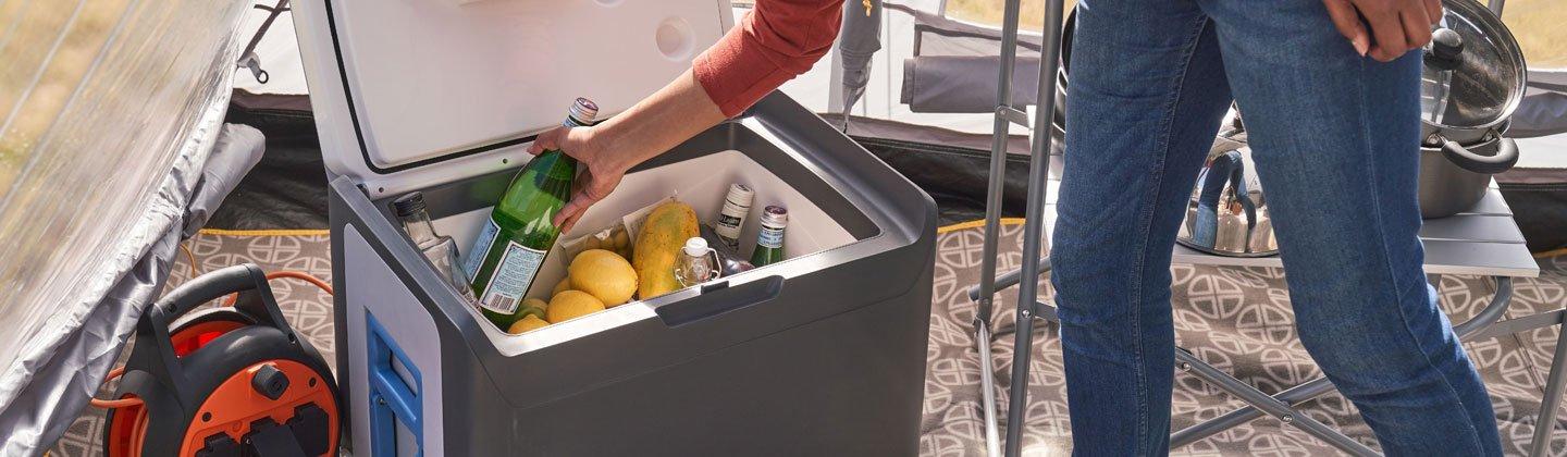 A person using a coolbox to store water
