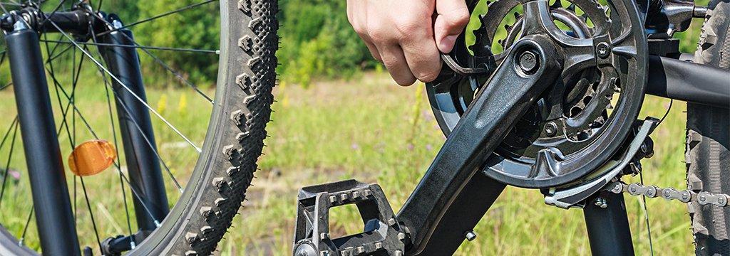 A closeup of a person performing bike maintenance