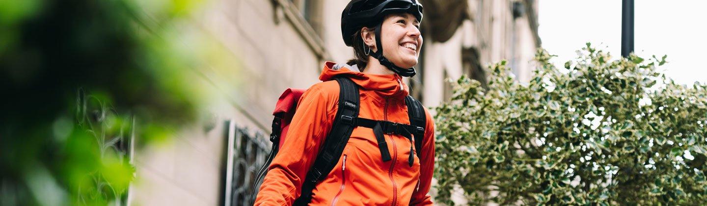 Closeup of a person wearing a cycling backpack and helmet