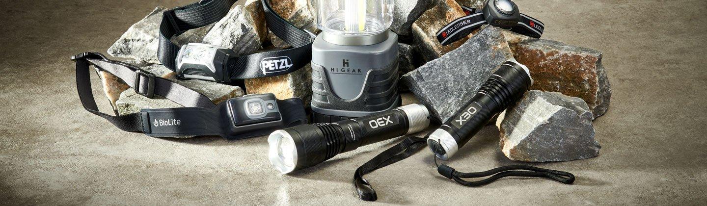 A studio photo of a collection of lighting equipment including headtorches and lanterns