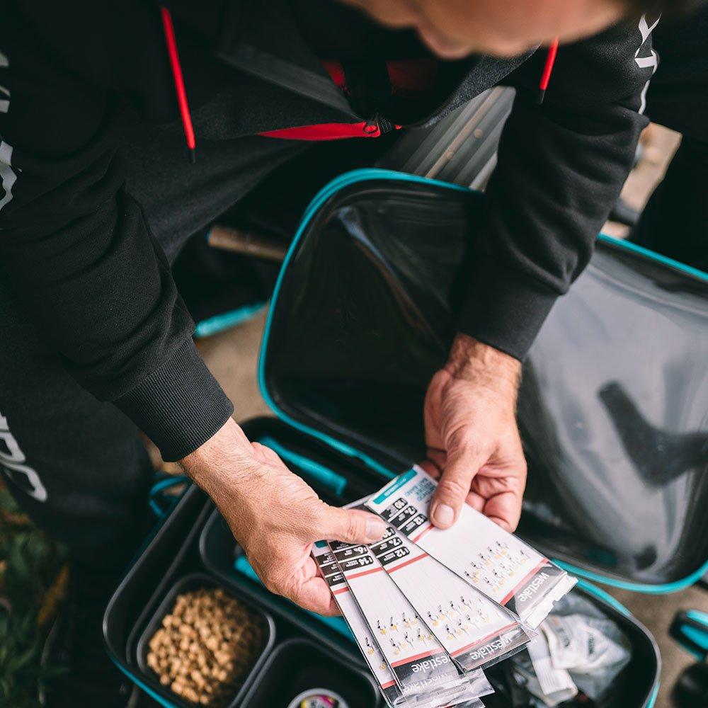 A person organising their fishing equipment