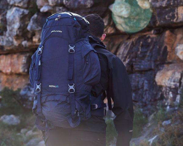 A closeup of a person walking with the image focused on the backpack