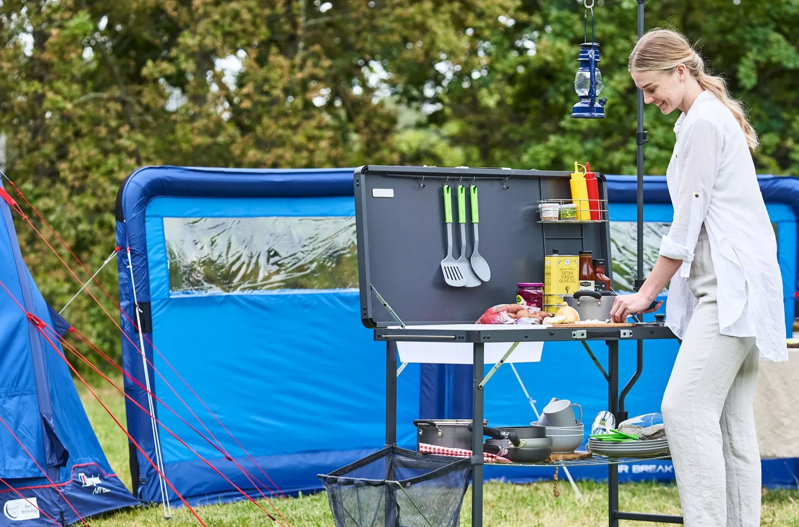 Person cooking whilst camping outdoors using the freeform kitchen