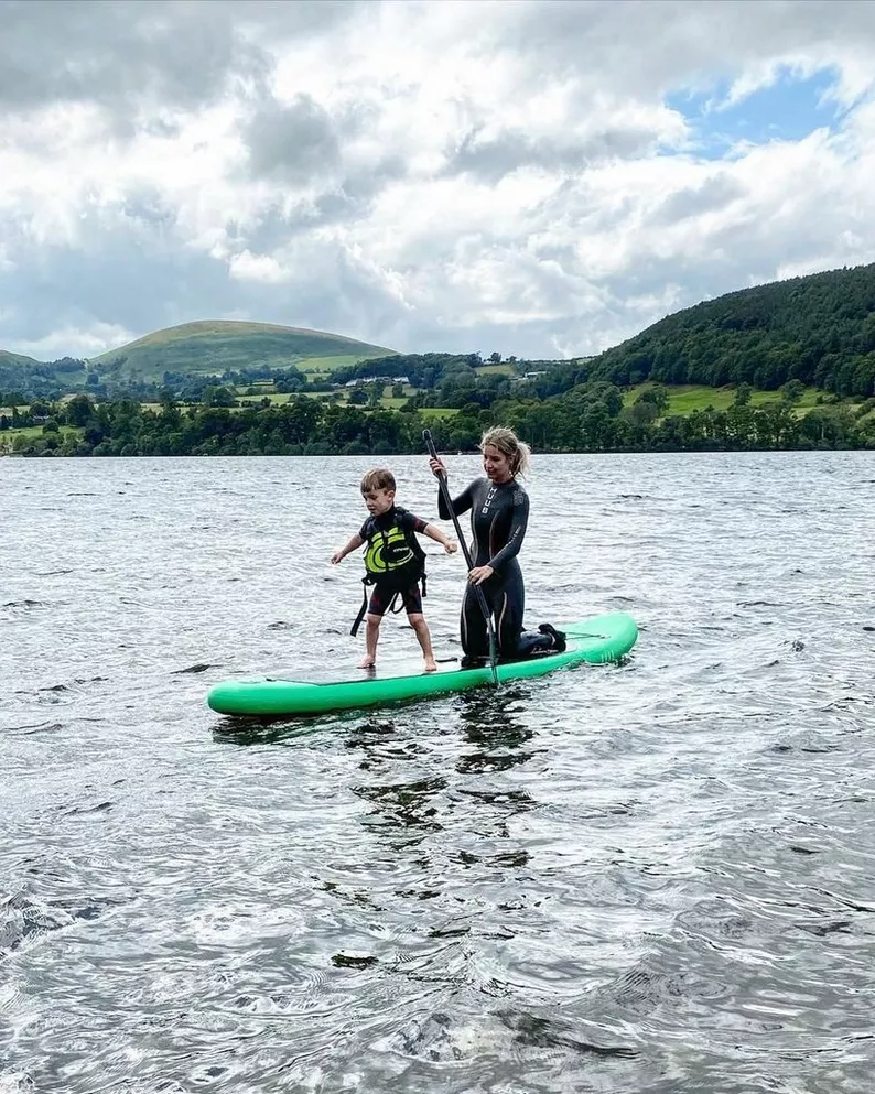Helen Skelton paddleboarding with her son