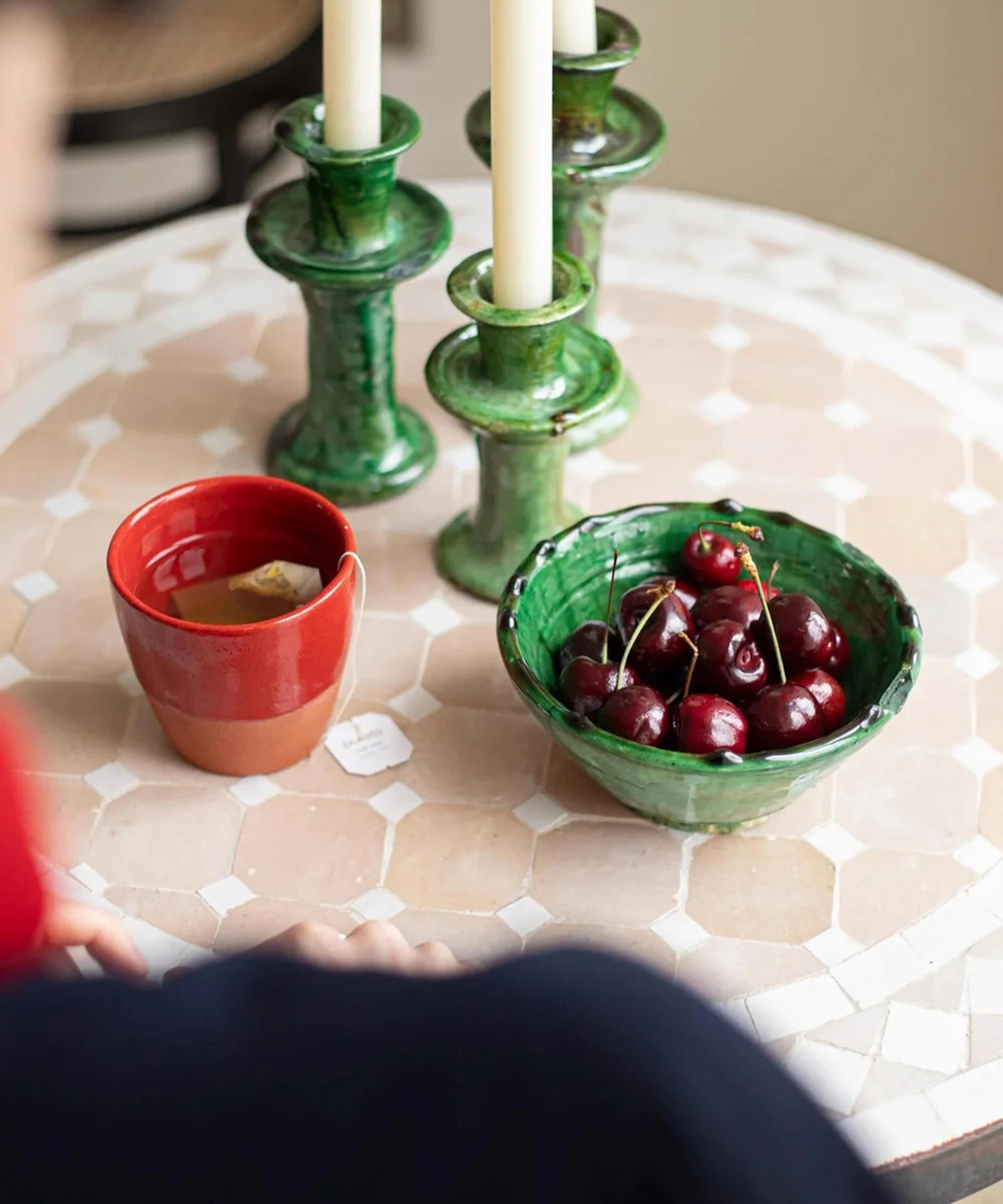 LRNCE ceramic mugs on a wall, with a cloudless blue sky behind them 