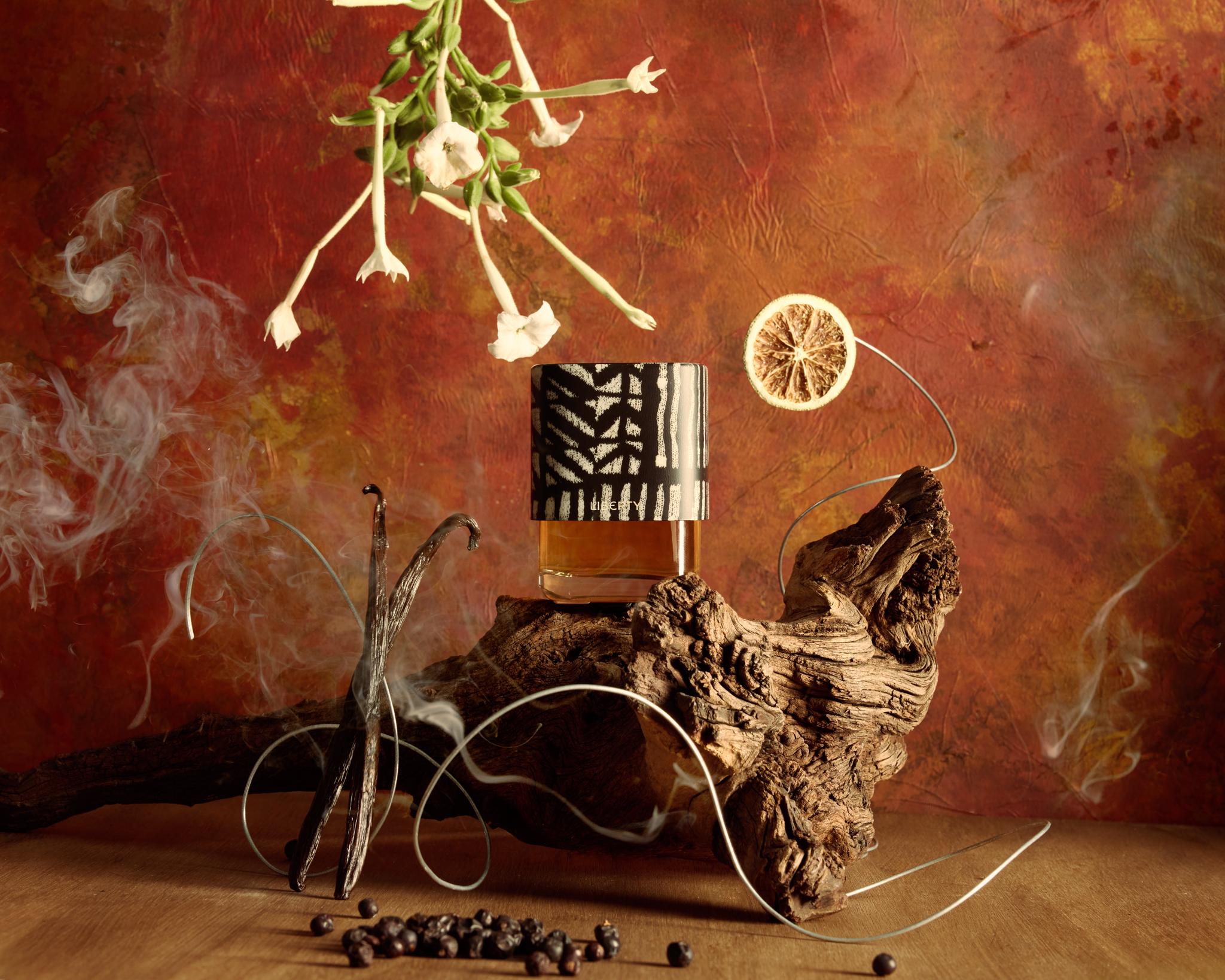 The new scent from Liberty LBTY. Fragrance, Liberty 1875, featuring a cap designed by artist Esther Gamsu