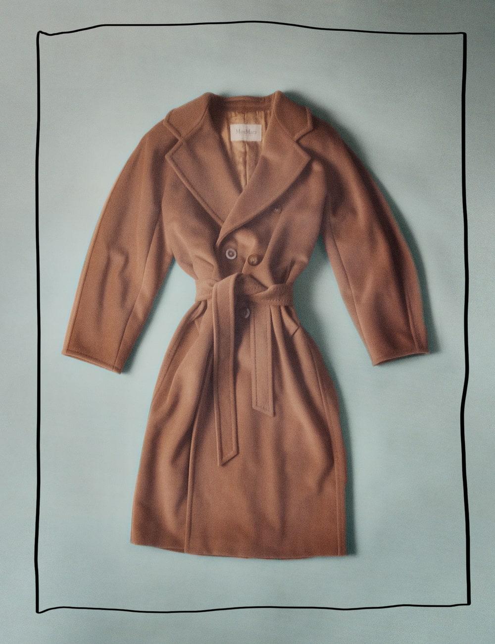 A camel coloured coat tied at the waist