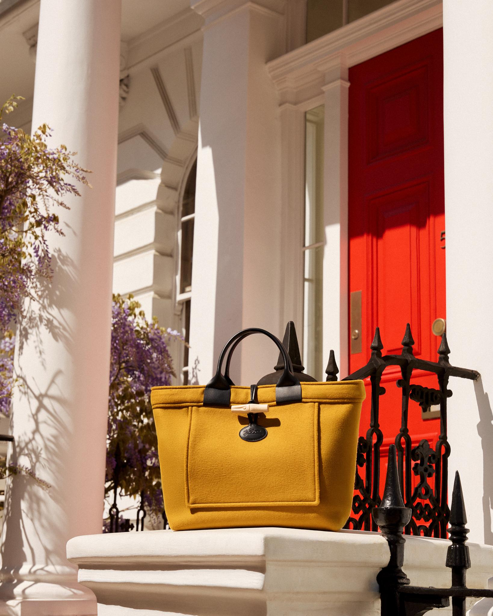 A yellow Le Roseau bag created as part of the collaboration between Longchamp and Gloverall  