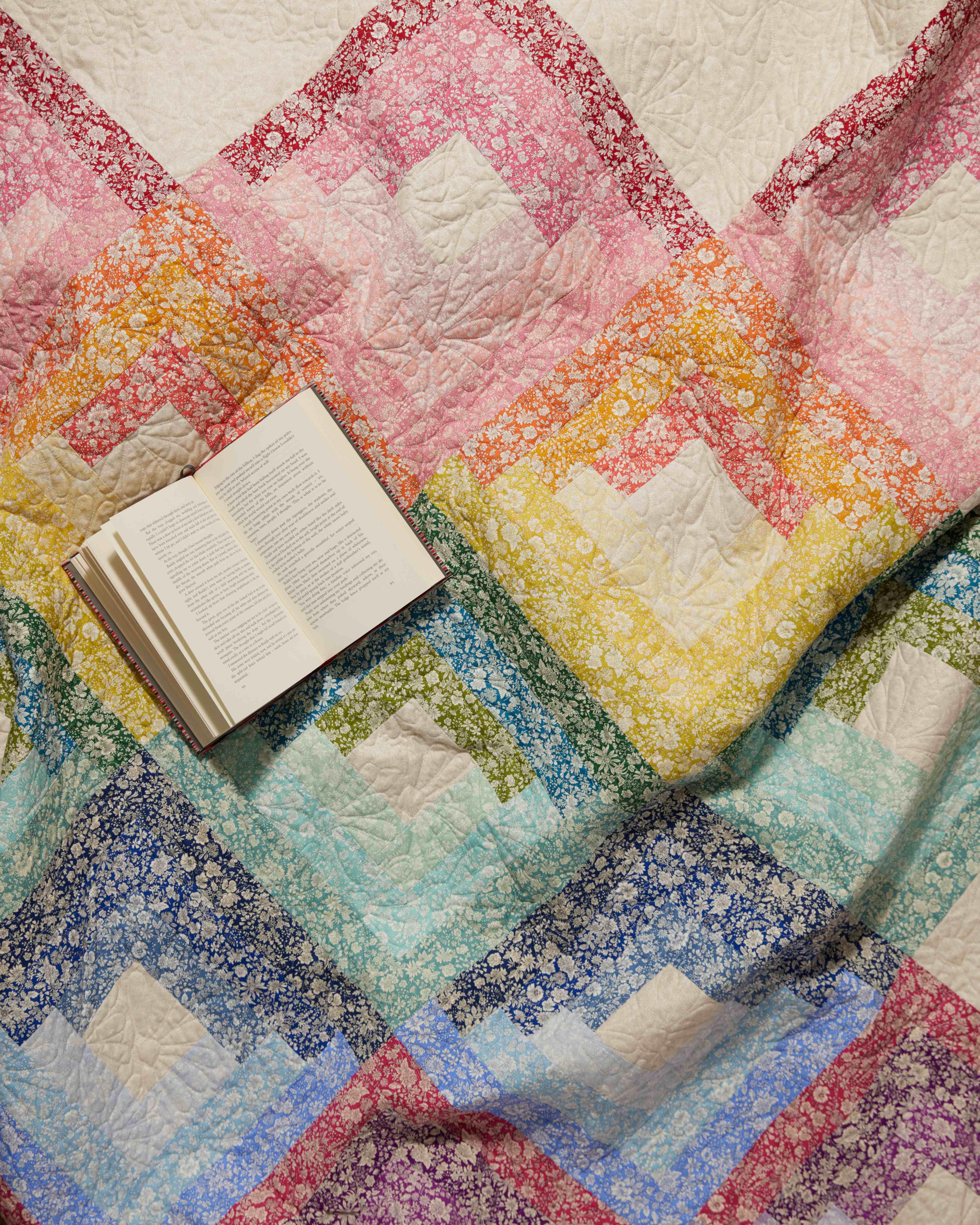 A quilt thrown over a velvet armchair 