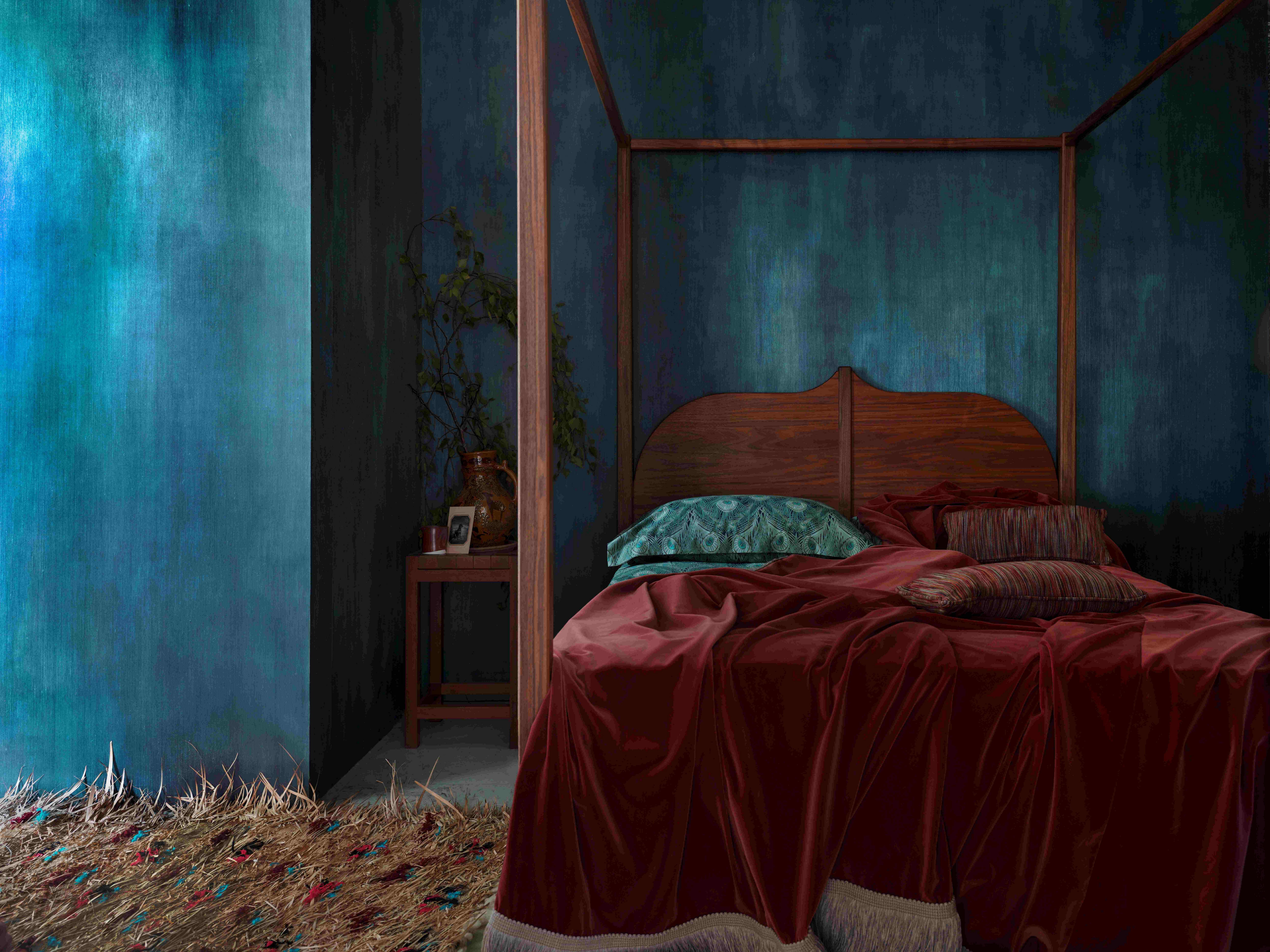 A four-poster bed in a room covered in Liberty Interiors Aurora Ink in Scarab wallpaper