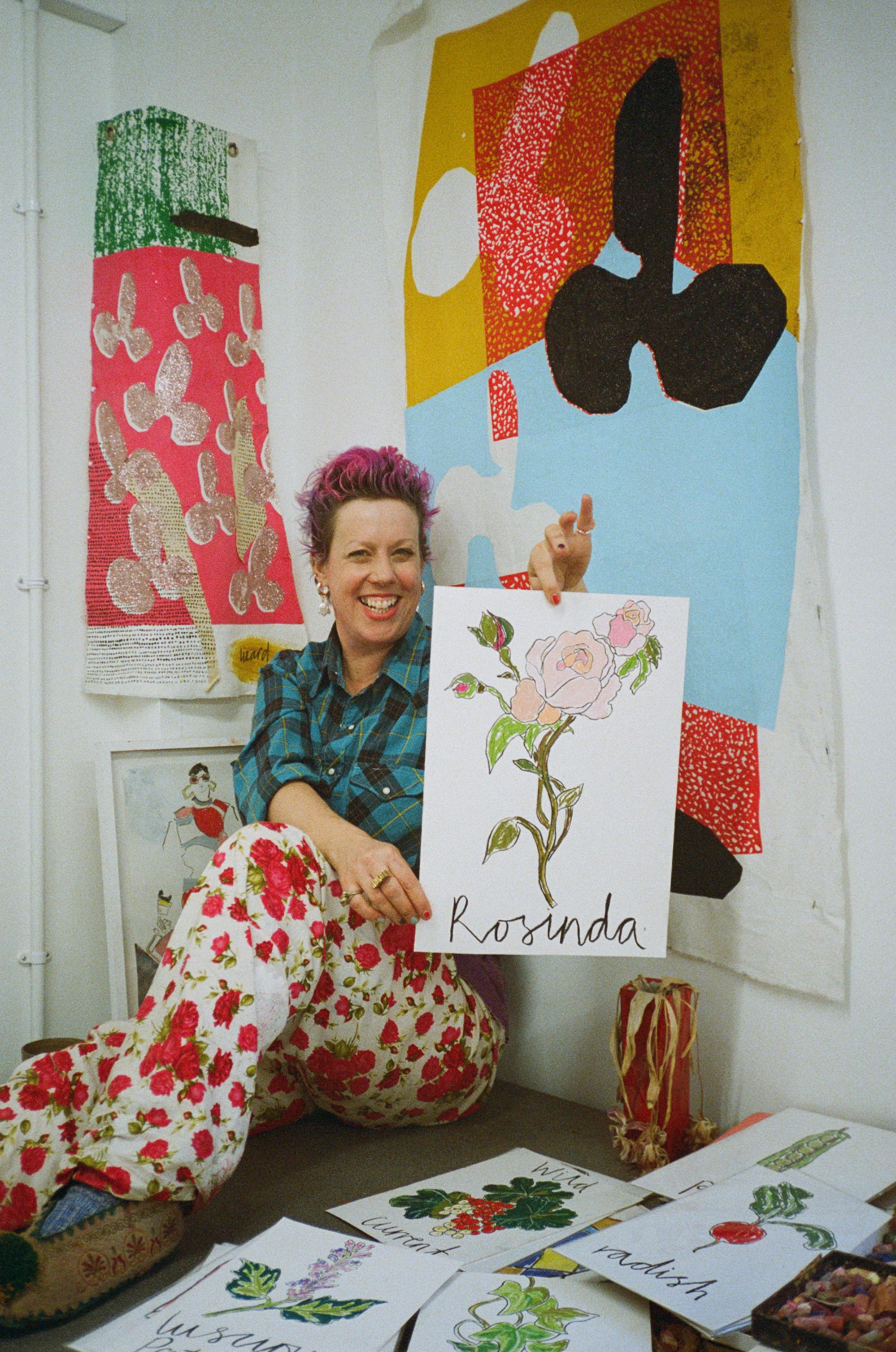 Helen Bullock holds her artwork inspired by Wild Rosinda
