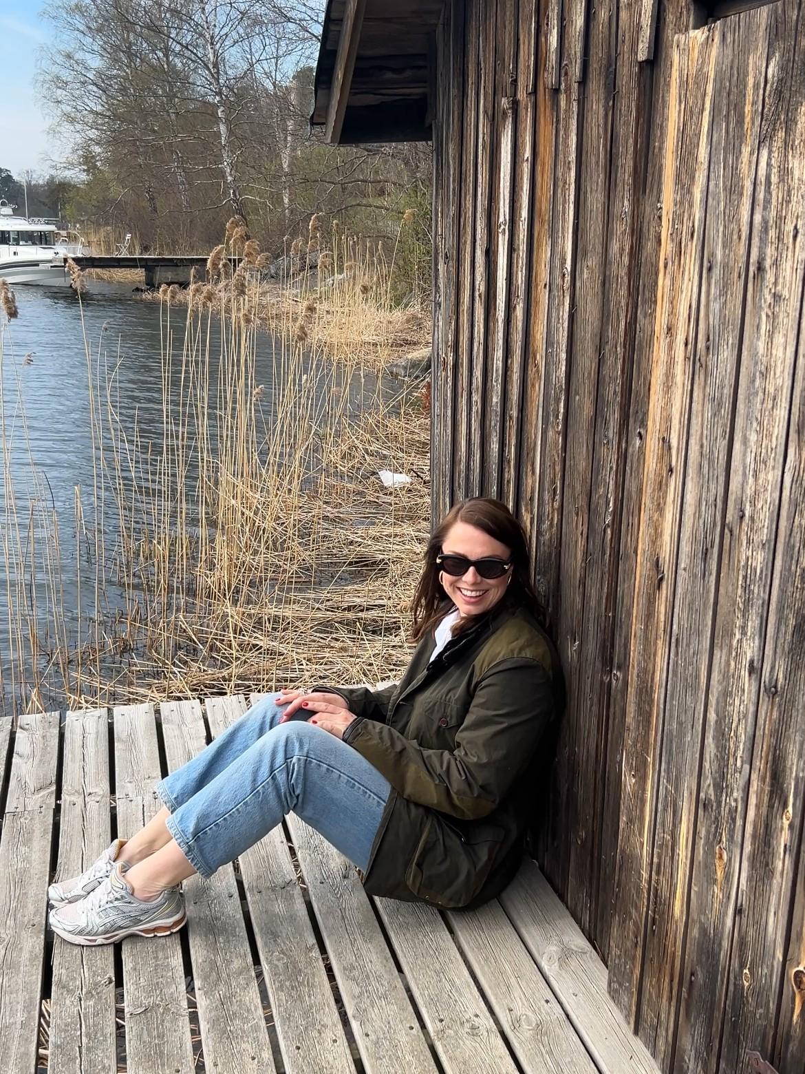 Mantle founder Josefin Landgård sits on a deck in front of her home