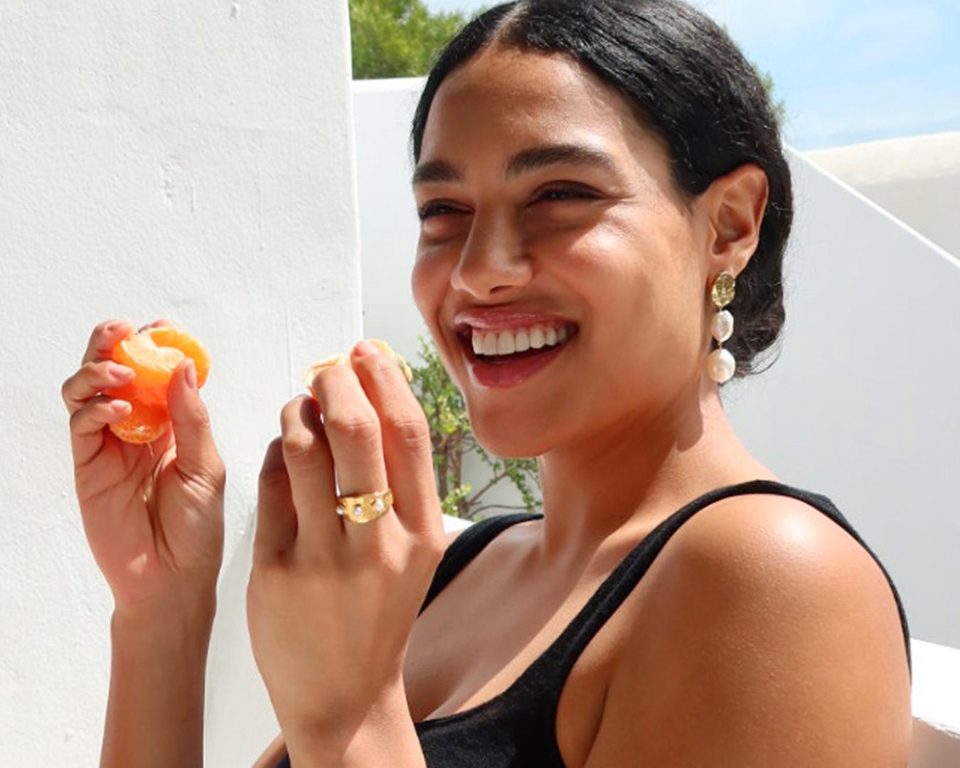 Model wearing Monica Vinader earrings and rings