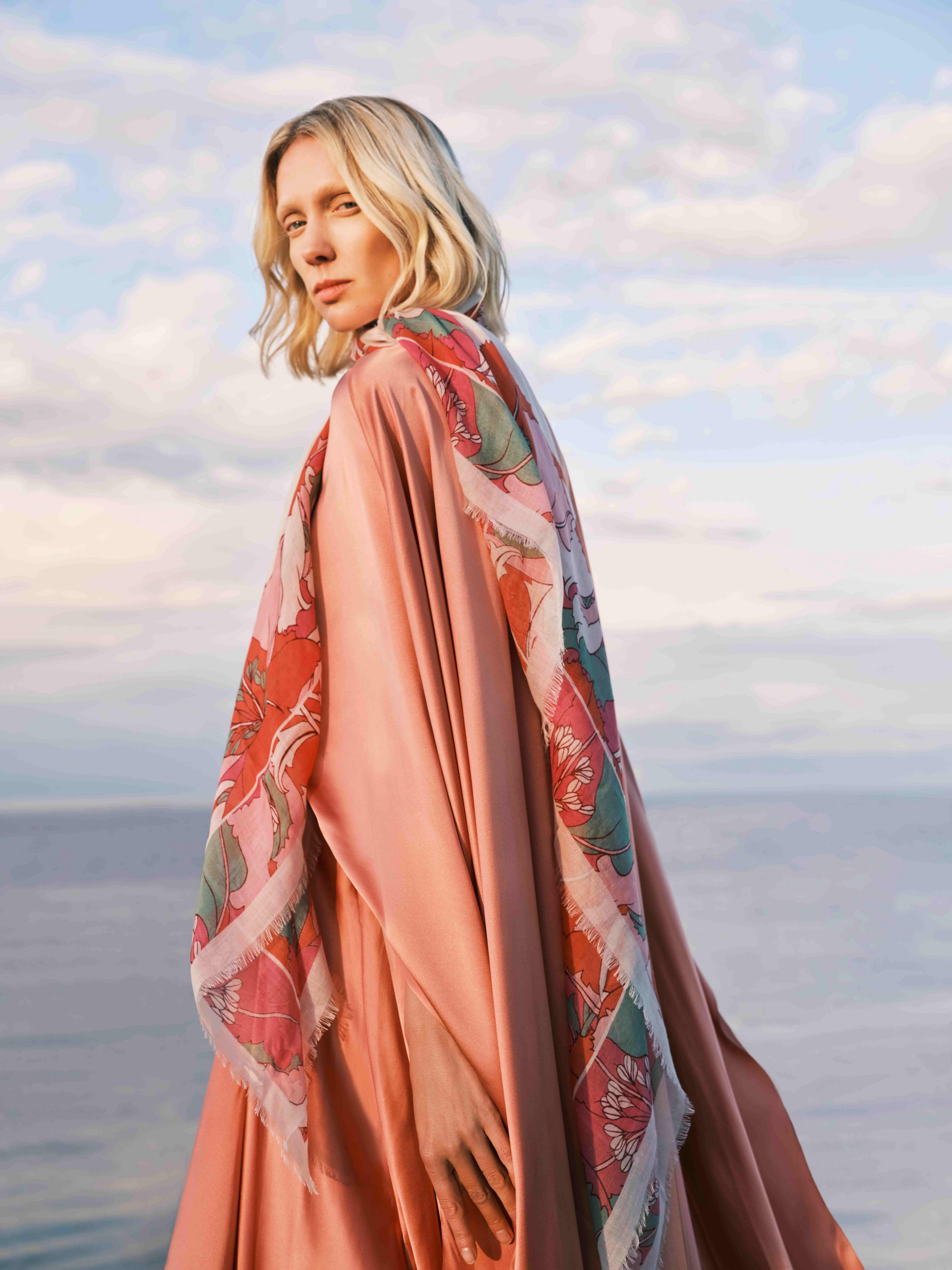 Model wearing orange and a floral Liberty scarf