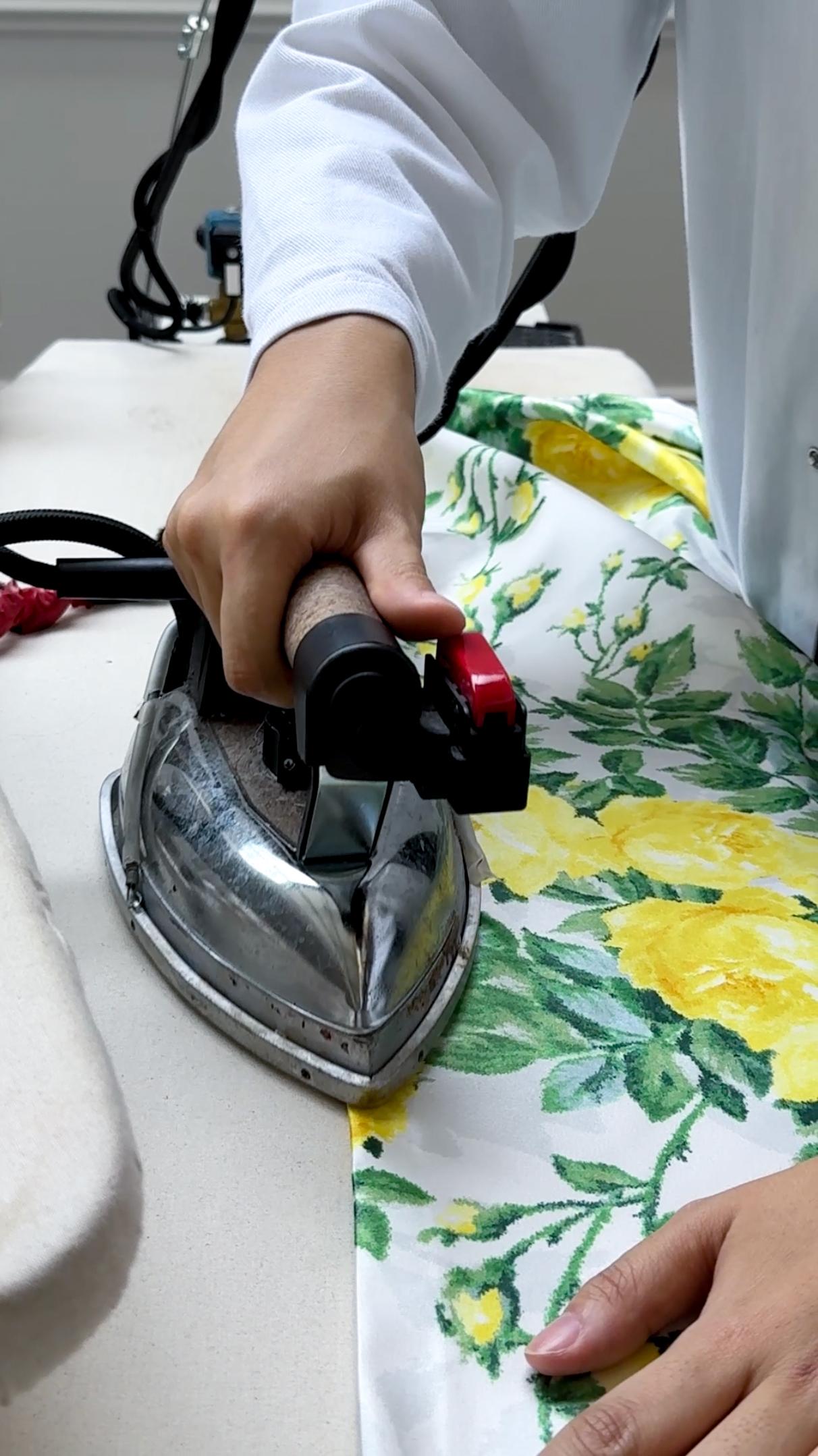 A piece of floral fabric being ironed