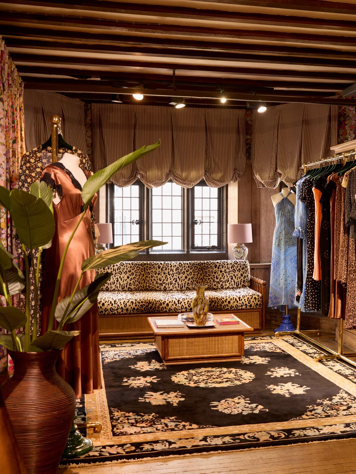 Rixo's space in the Liberty store. Complete with elegant vintage inspired dresses, a leopard print sofa, floral curtains and a large ornate rug
