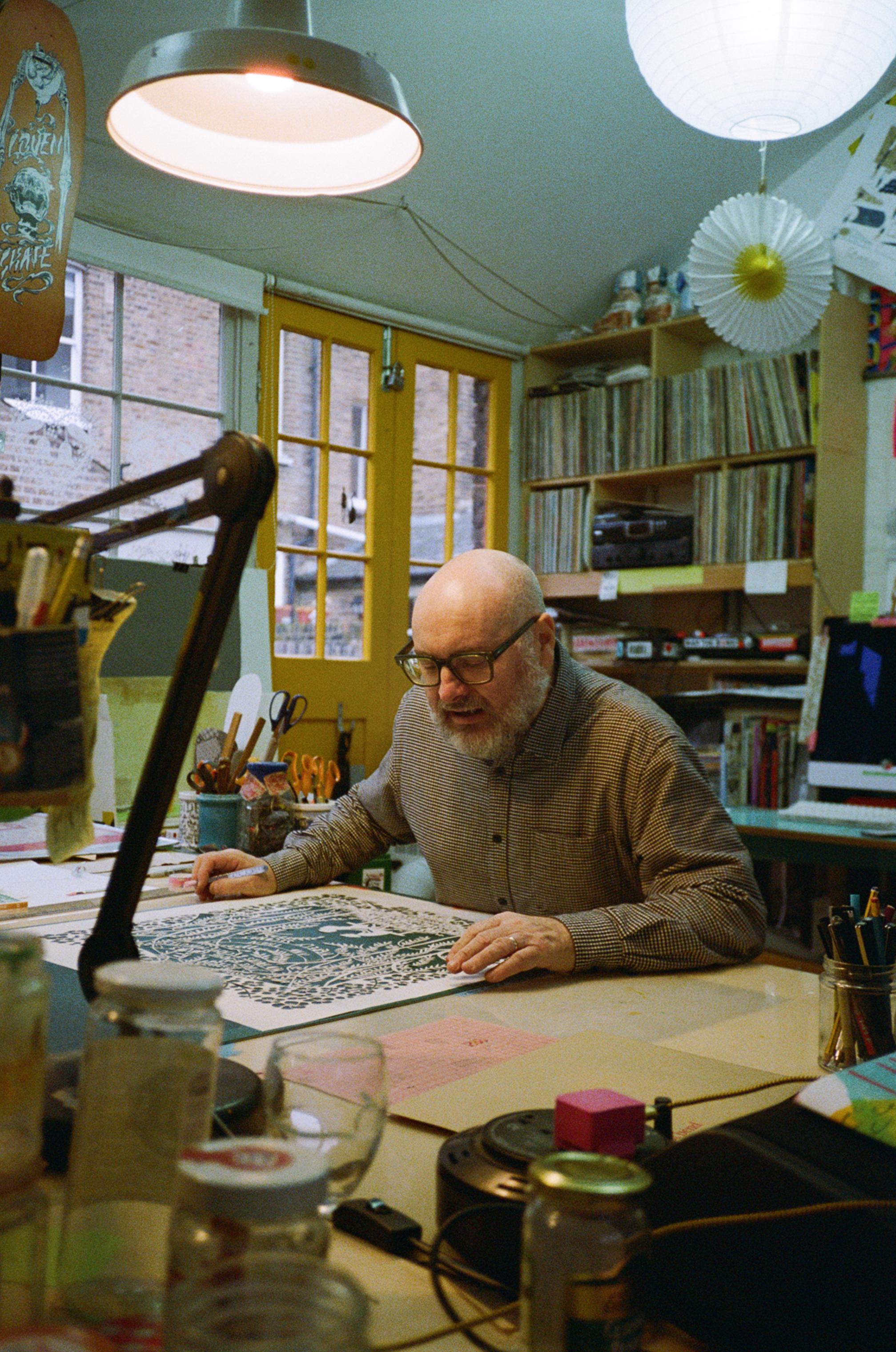 Rob Ryan works on his papercutting creation in his London studio