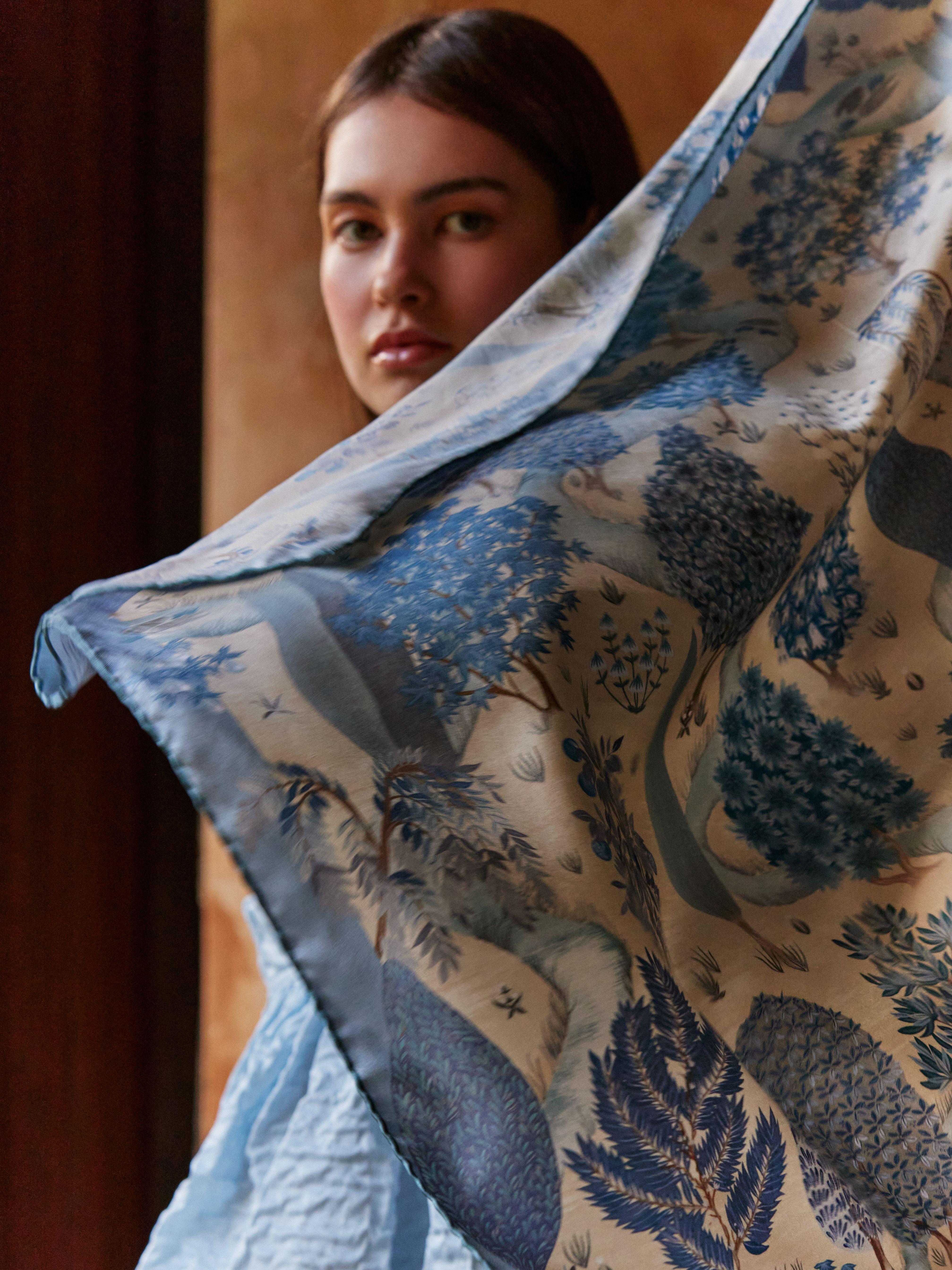 A woman wears a Liberty scarf