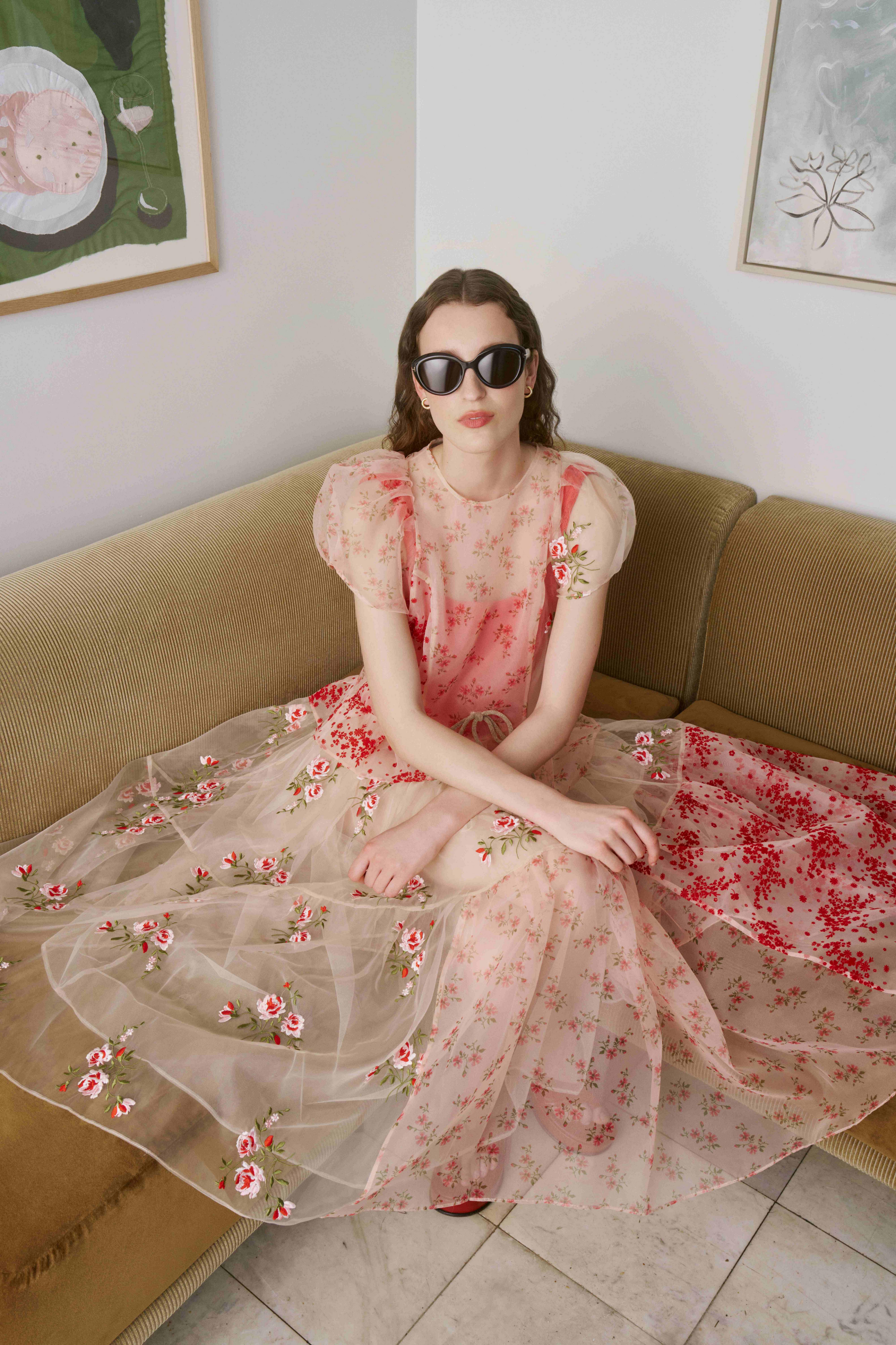 Model wearing Tom Ford sunglasses sitting on a sofa