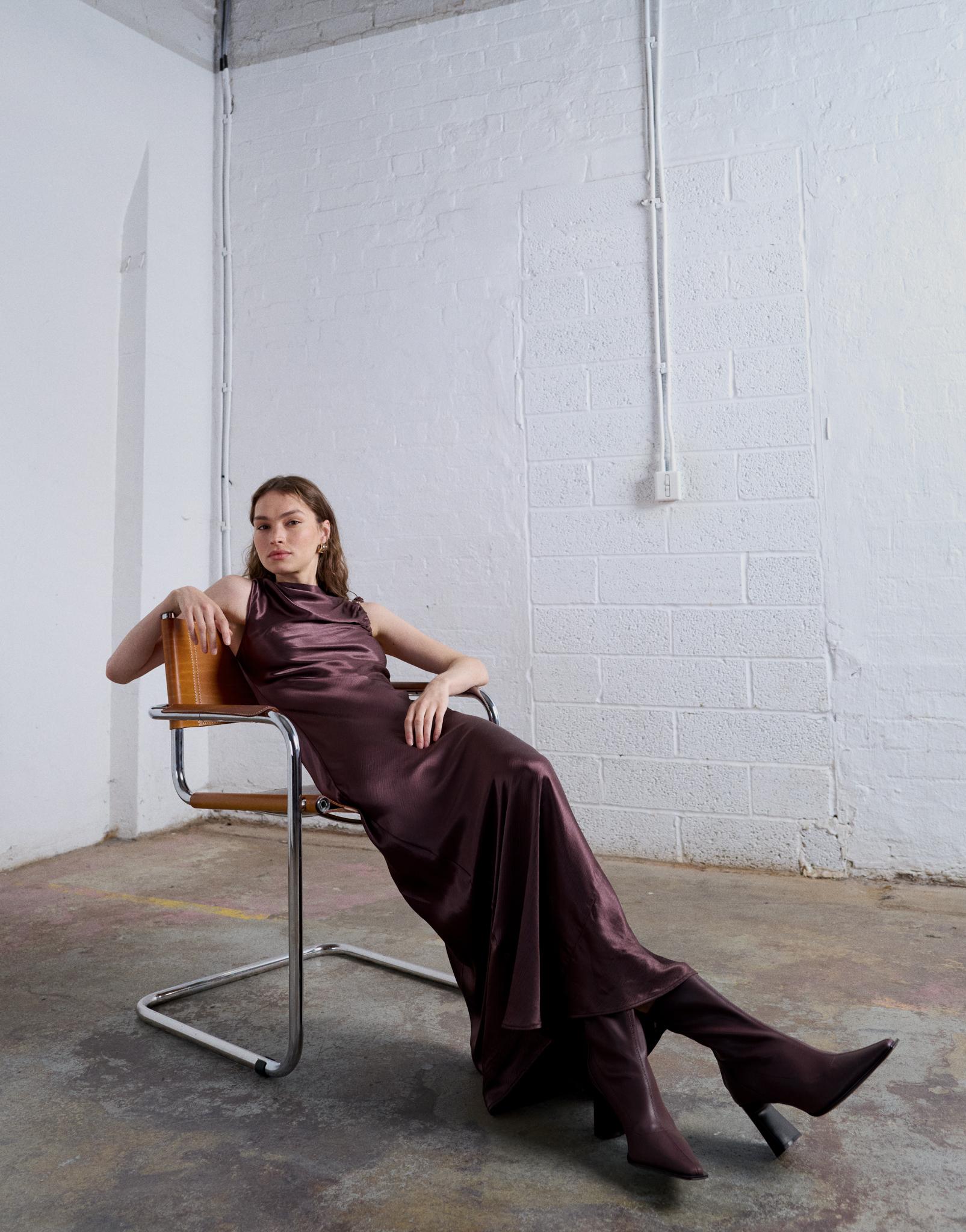 A woman wears a checked two-piece from Peachy Den, paired with red tights