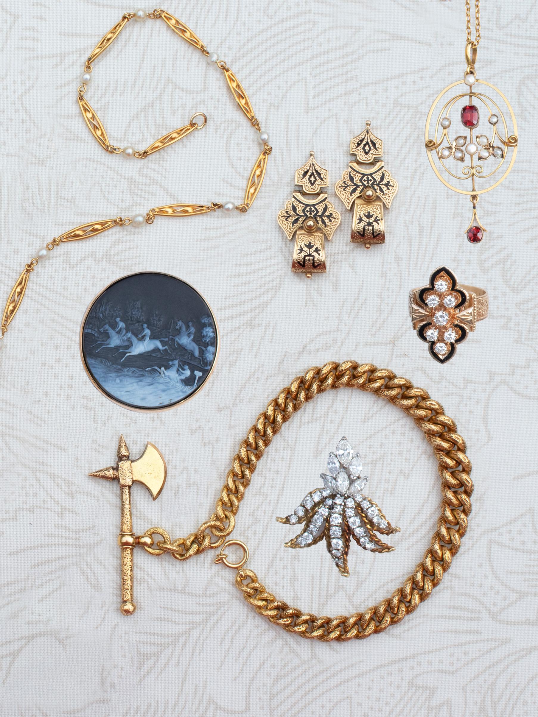 A selection of vintage gold jewellery including a Victorial axe bracelet