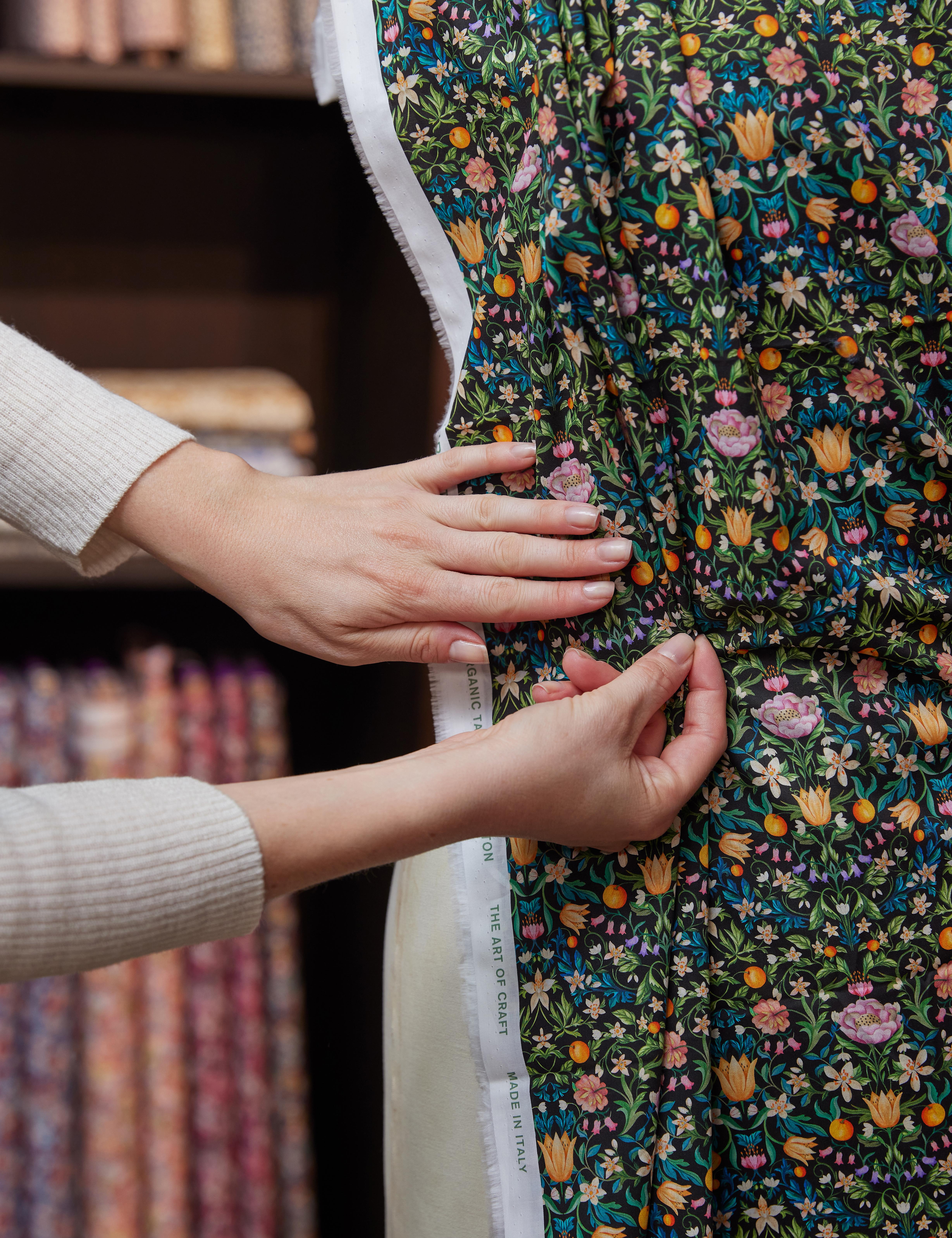 liberty fabric team pinning william morris fabric onto tailors dummy