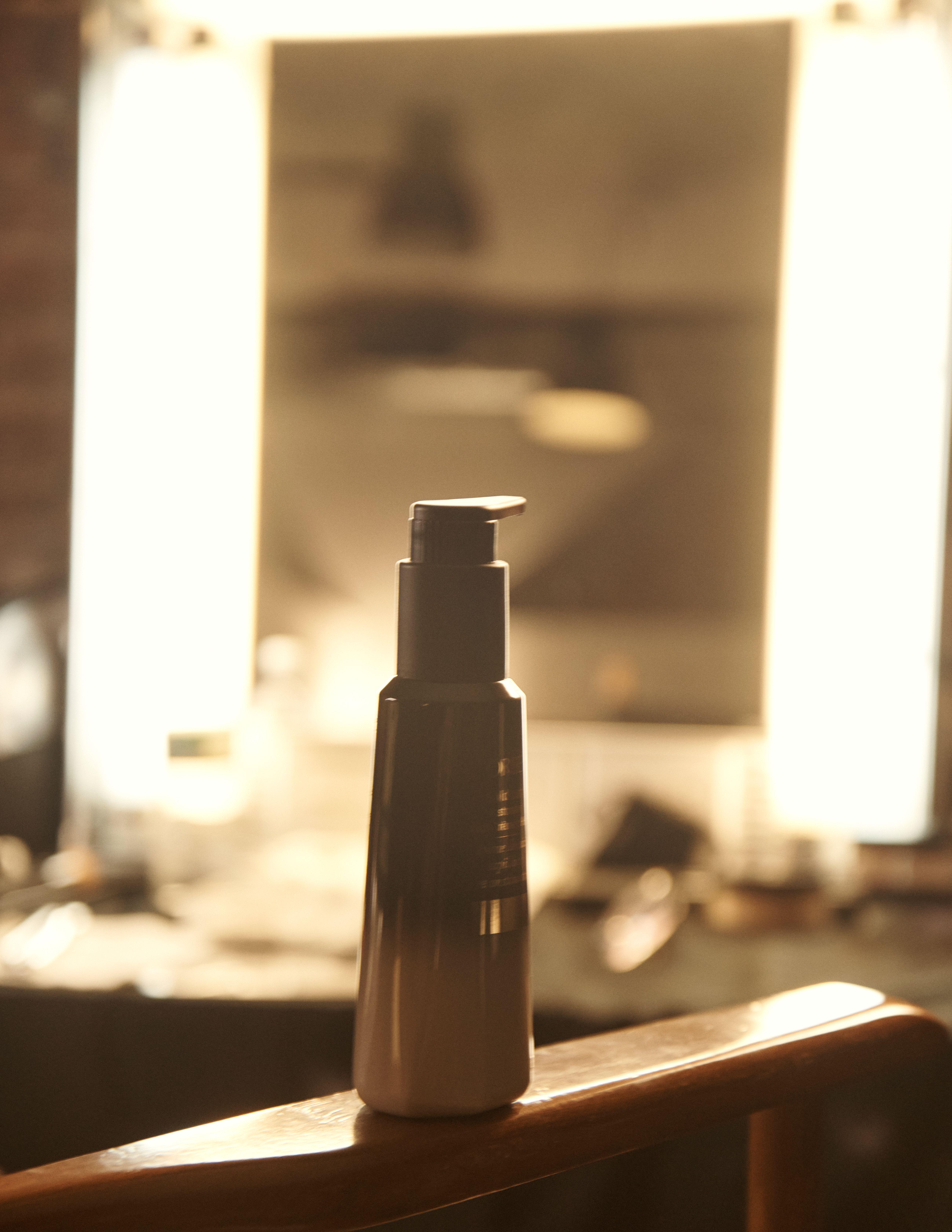 A bottle of product in a dimly lit room