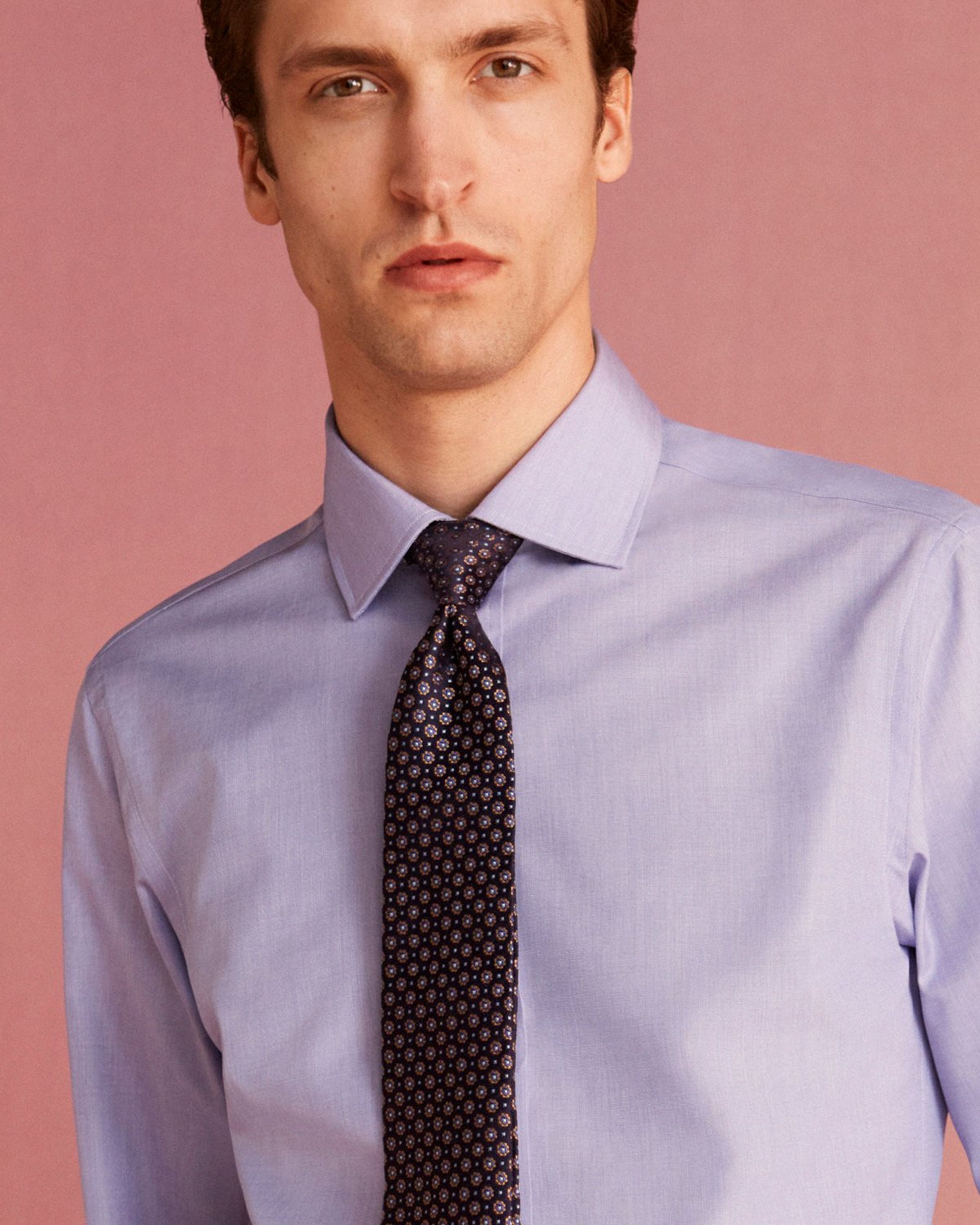 Man wears blue shirt with tie