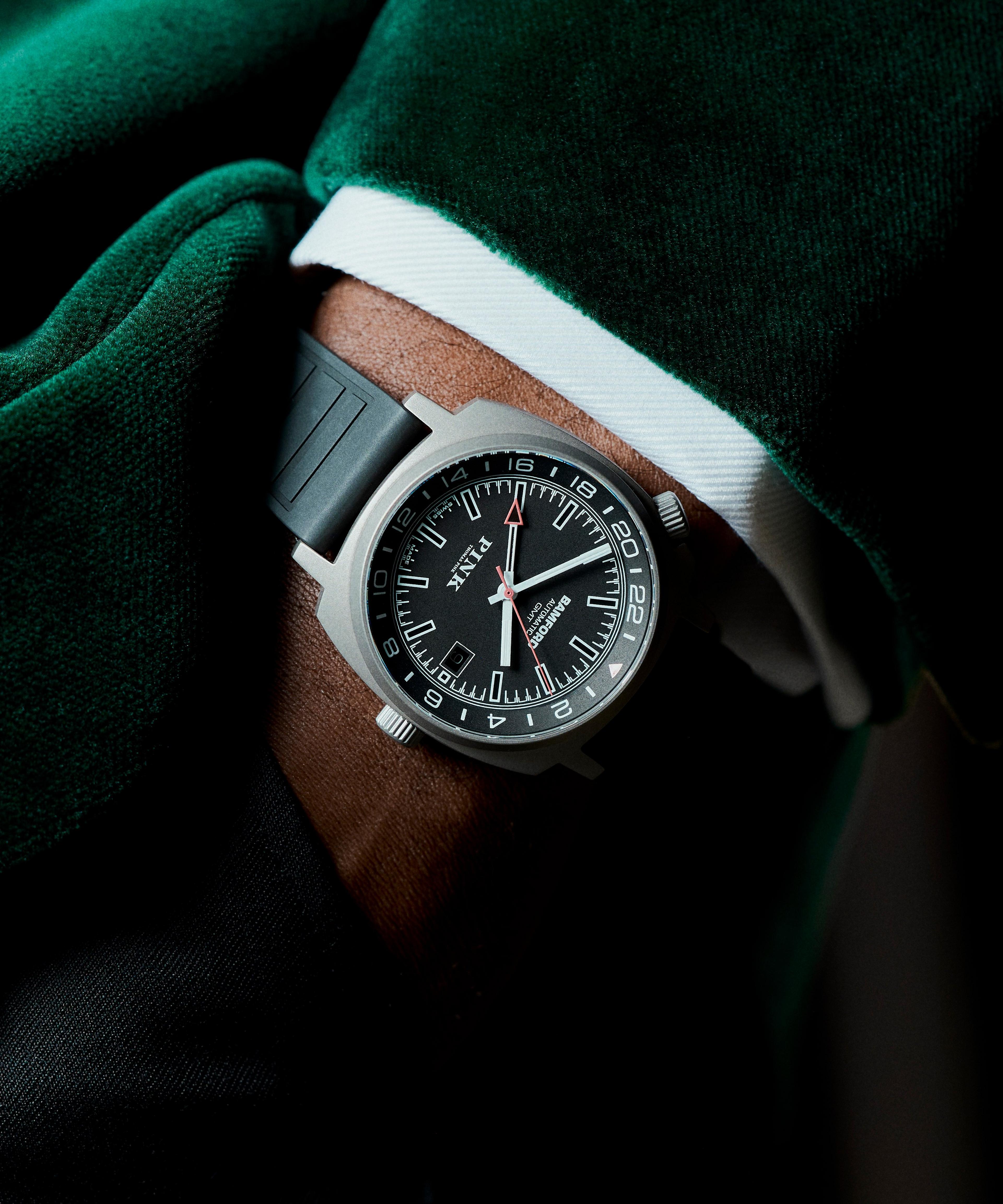A Bamford watch on the wrist of a man wearing a green jacket