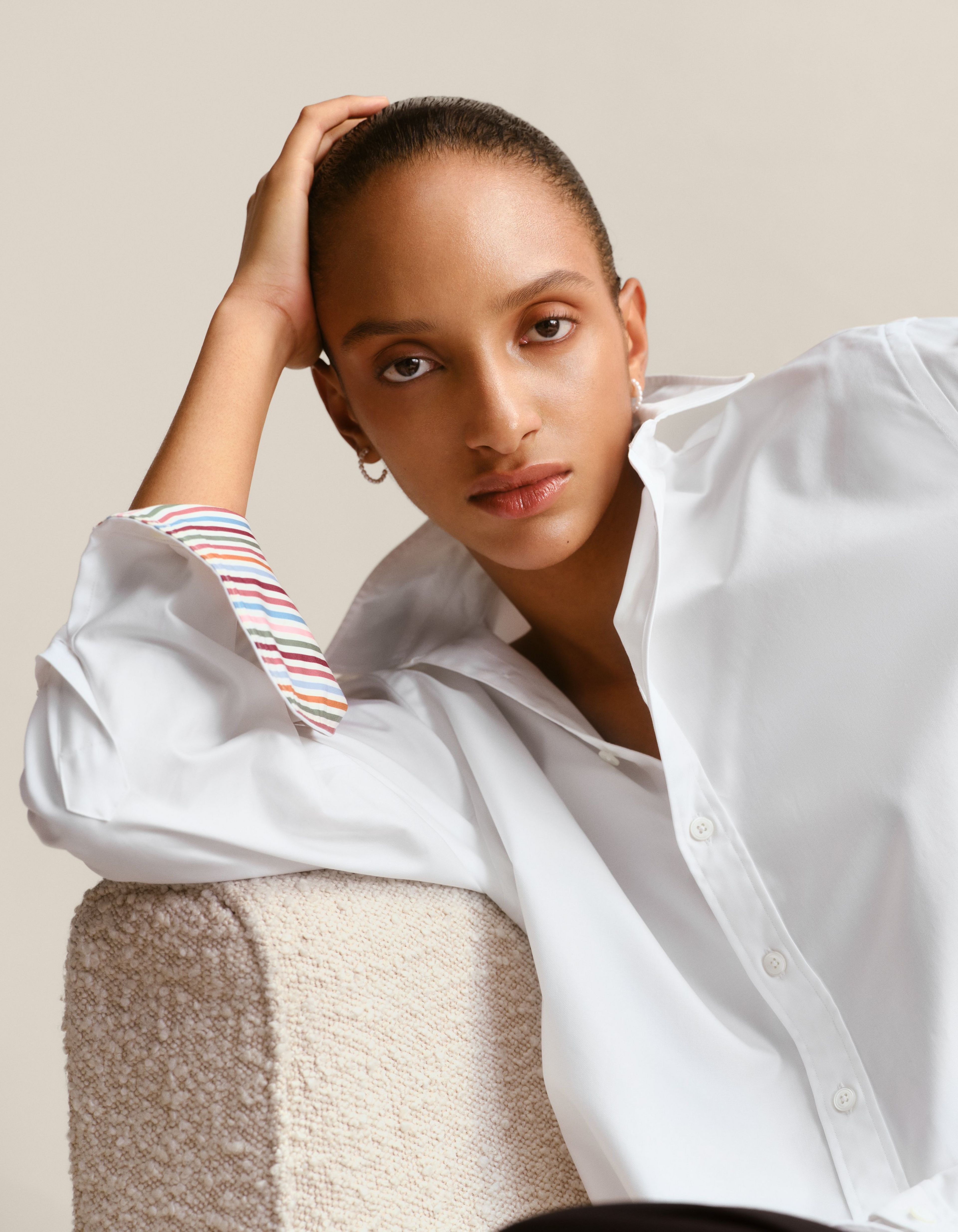 A women wears a white shirt with contrast cocktail cuffs