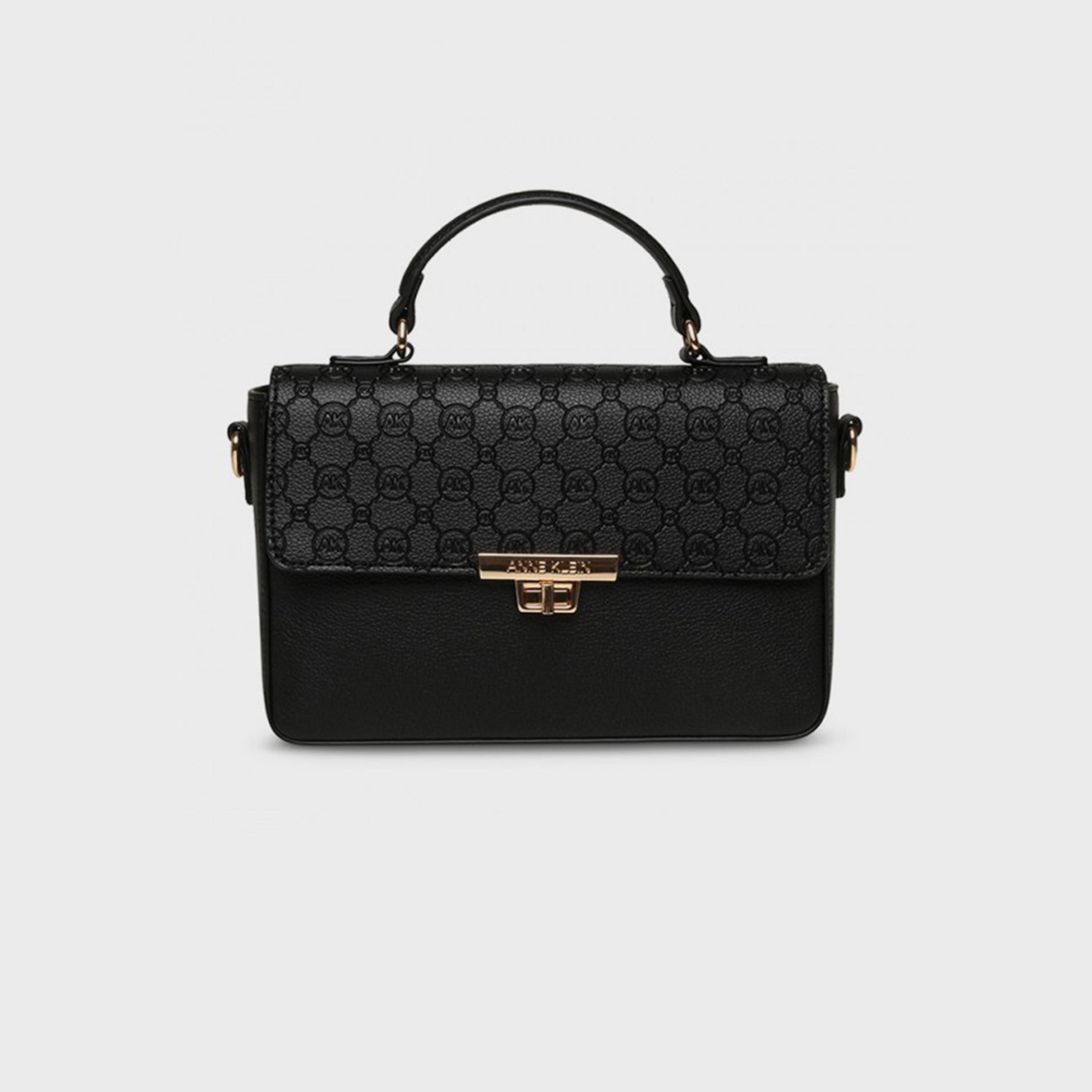 آن كلين - شنطة يد بمقبض علوي مزينة بشعار المونوغرام وقفل دوار-women-bagsandwallets-handbags-image-1