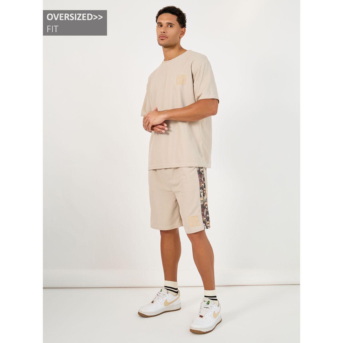 طقم منسق من شورت وتيشيرت فضفاض بطبعة جرافيك-men-clothing-coordsets-image-1
