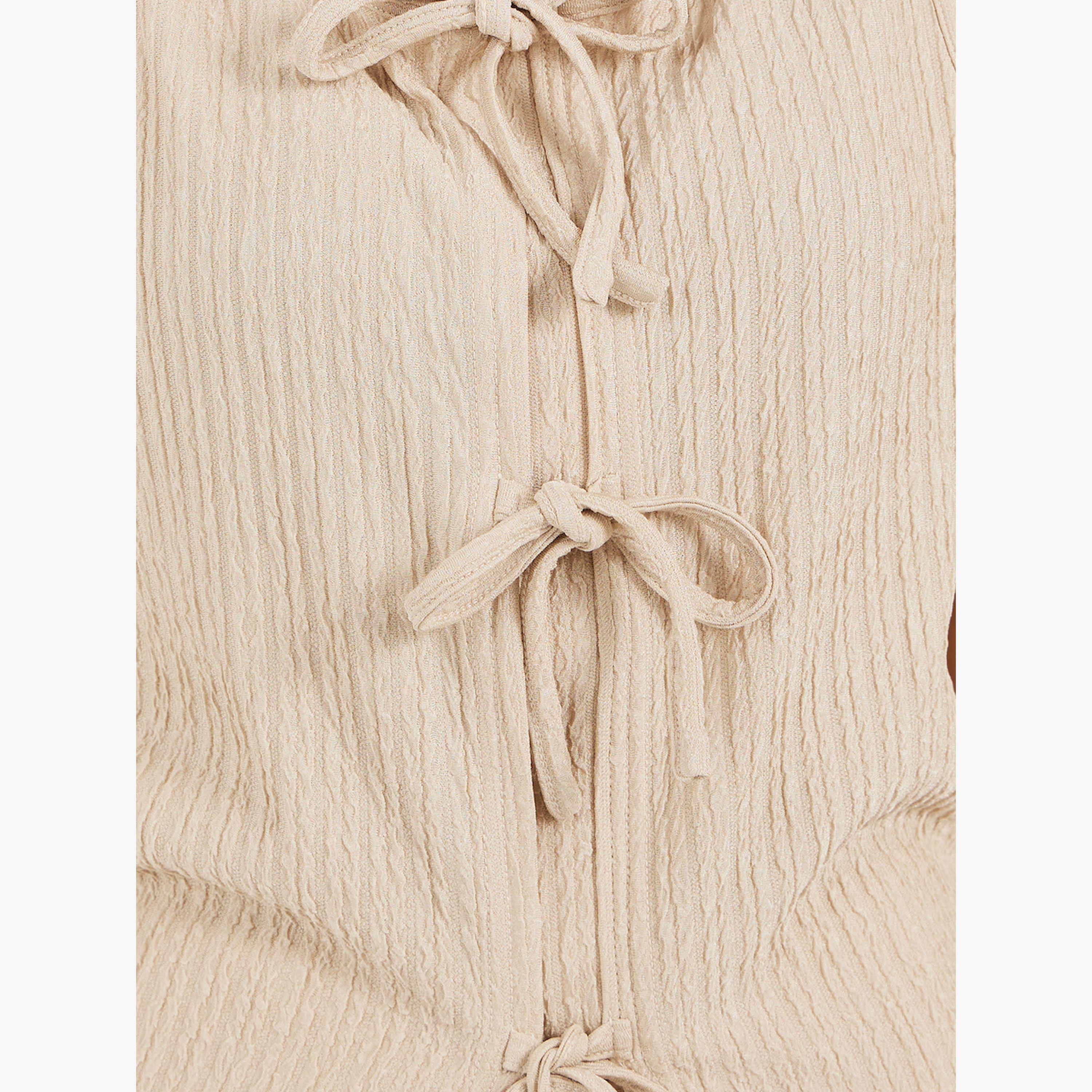ستايلي -  بلوزة نسائية محبوكة بدون أكمام برباط أمامي مضلع باللون البيج-women-clothing-tshirts-image-3