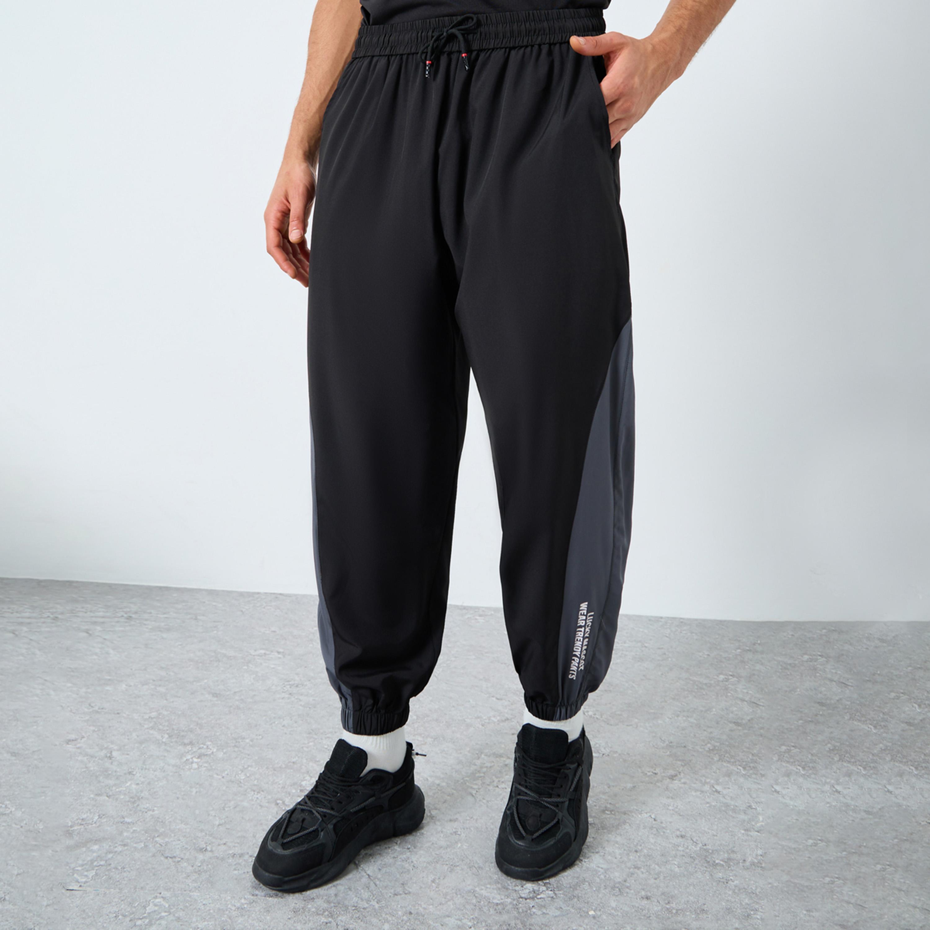 Styli Men Black Placement Print Regular Fit Track Pants with Side Panel-men-clothing-sportswearandactivewear-bottoms-joggers-image-1