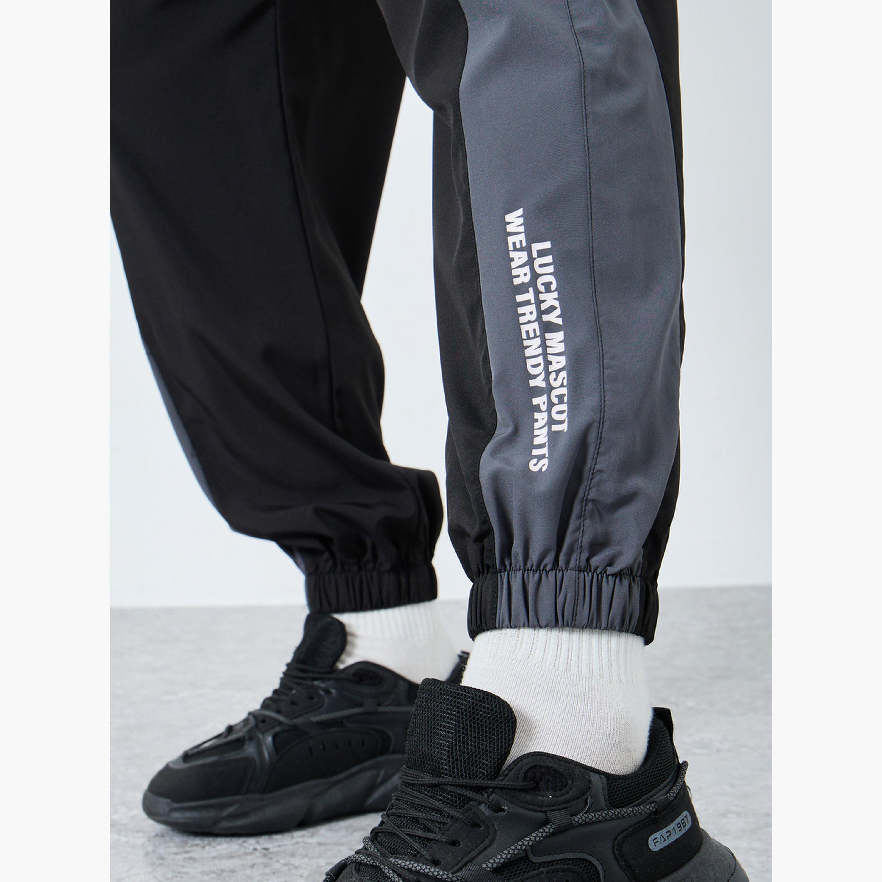 Styli Men Black Placement Print Regular Fit Track Pants with Side Panel-men-clothing-sportswearandactivewear-bottoms-joggers-image-4