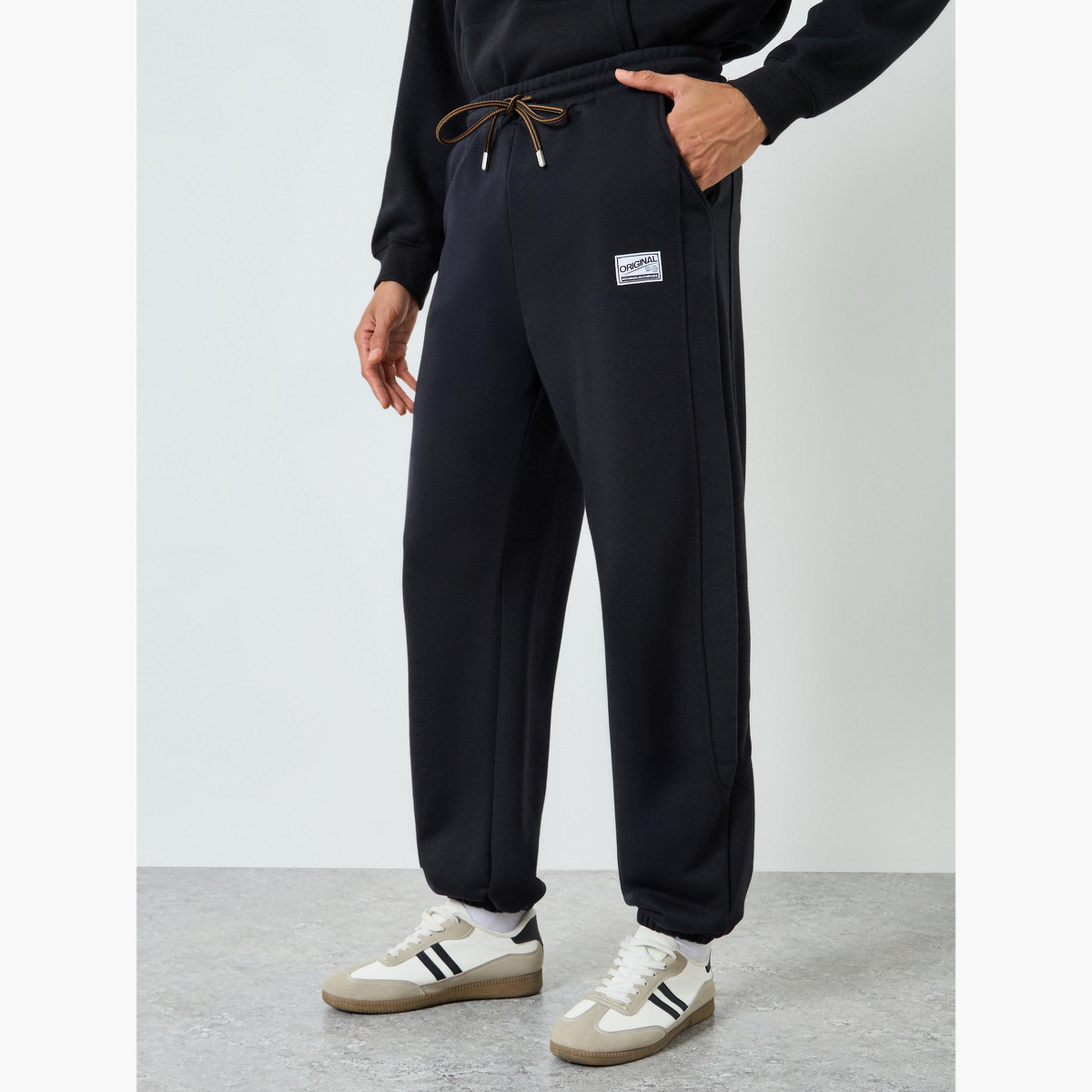 Styli Men Black Elastic Hem Relaxed Badge Joggers-men-clothing-bottoms-joggers-image-1