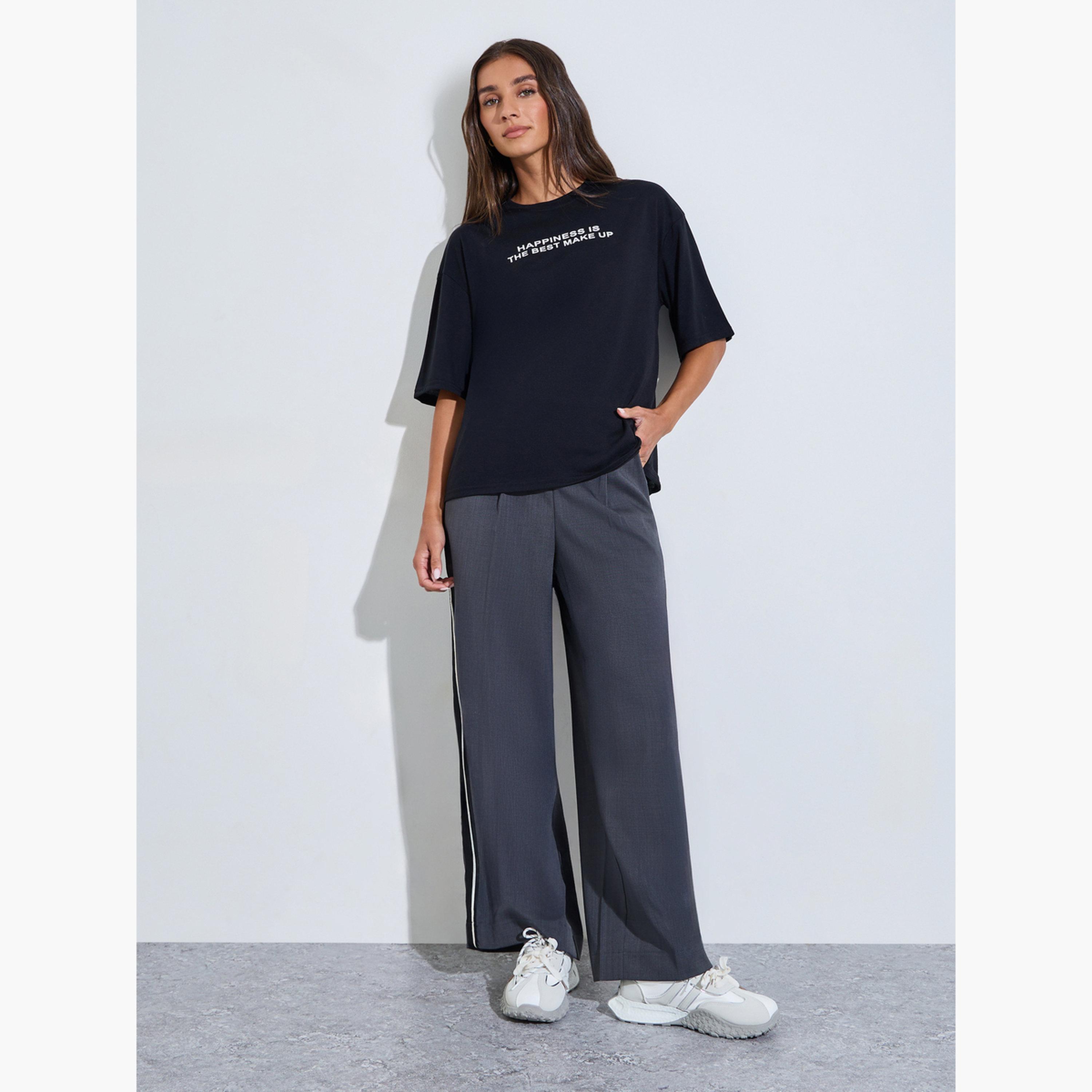 تيشيرت واسع بكتف منسدل وطبعة شعار لون أسود-women-clothing-tshirts-image-2
